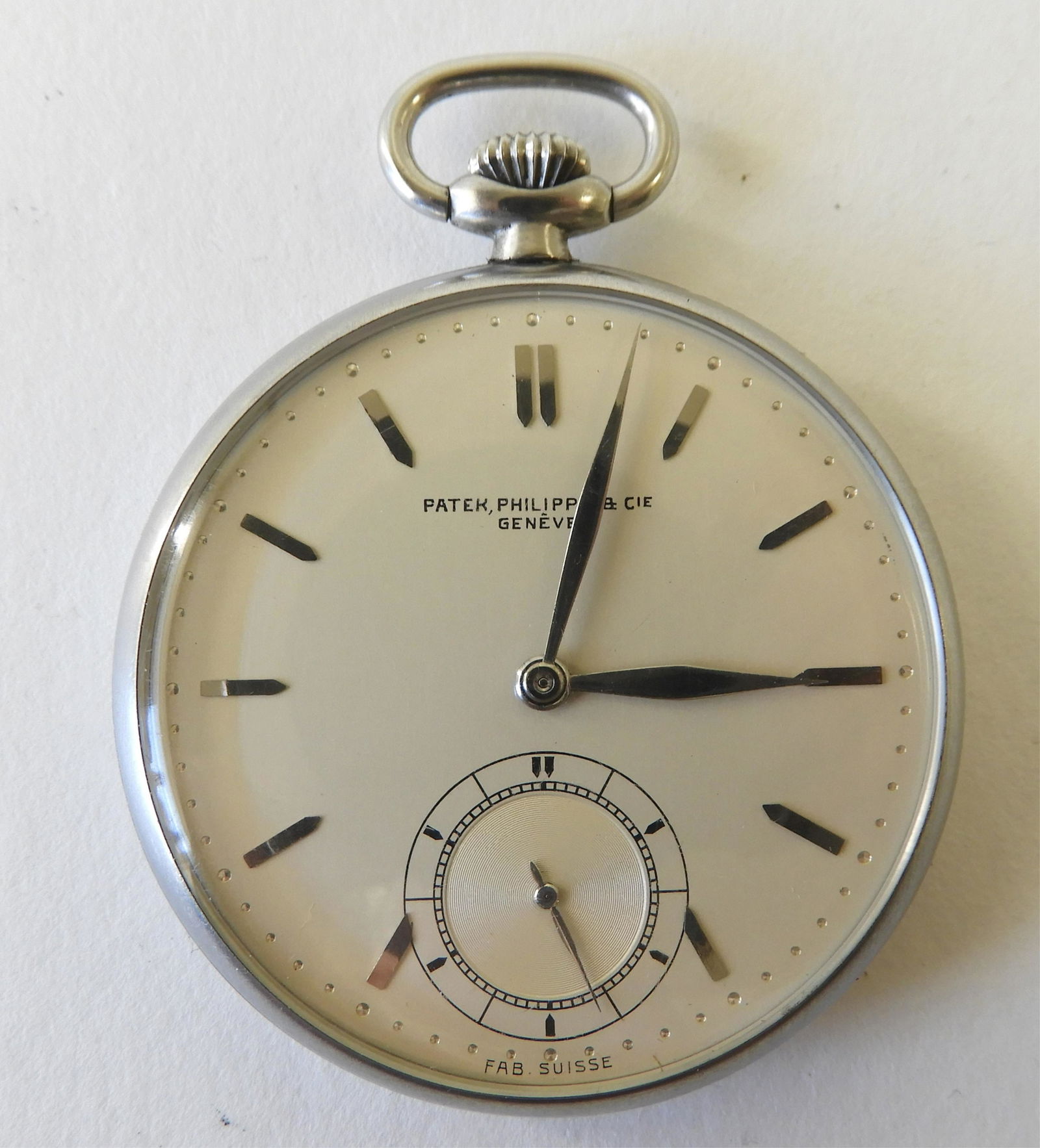 Patek Philippe Stainless Steel Pocket Watch: Open face stainless steel case, circa 1925-1930, silvered dial stamped “Patek, Philippe & Cie / Genève / Fab. Suisse”, raised steel bullet chapters, seconds subsidiary dial, case interior stamped