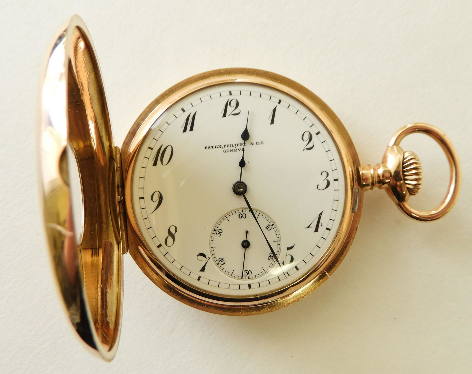 Patek Philippe & Cie 18k Gold Pocket Watch: Oversize monogram and black enamel Arabic numerals 18k yellow gold demi hunter case, circa 1900, white enamel dial stamped “Patek, Philippe & Cie / Genève”, black Arabic numerals, seconds subsidi