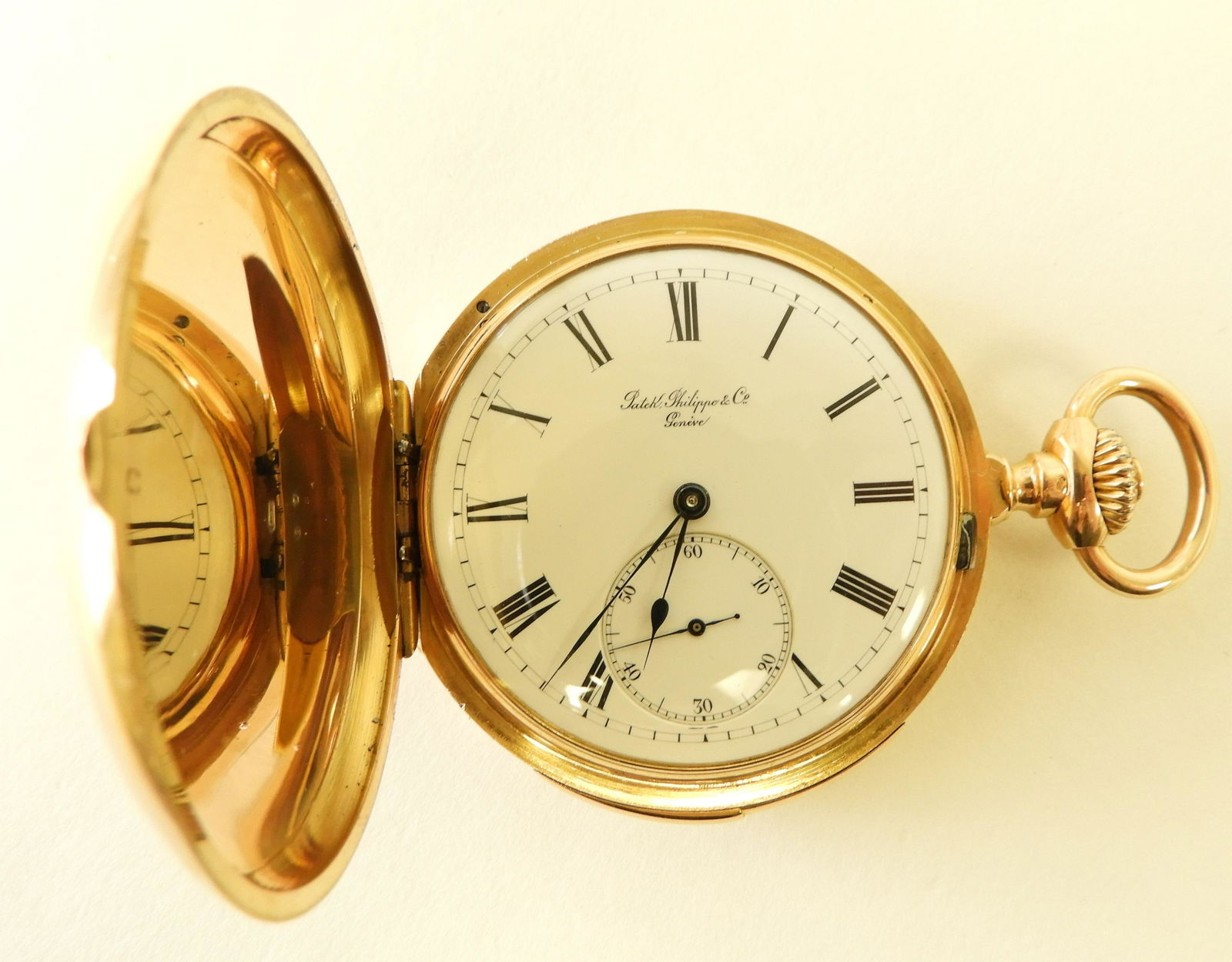 Patek, Philippe & Co 18K Gold Pocket Watch, c 1883: Oversize monogram polished 18k yellow gold hunter case, circa 1883, white enamel dial stamped “Patek, Philippe & Co / Genève”, black Roman numerals, seconds subsidiary dial, case interior stamped