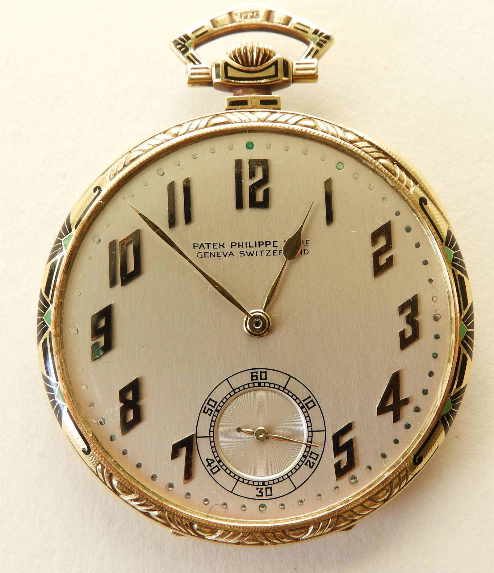 Patek Philippe 18K Gold Art Deco Pocket Watch: Open face Art Deco 18k yellow gold case accented with black and green enamel, circa 1925, brushed silver dial stamped “Patek Philippe & Cie / Geneva, Switzerland”, gold Arabic numerals, seconds su