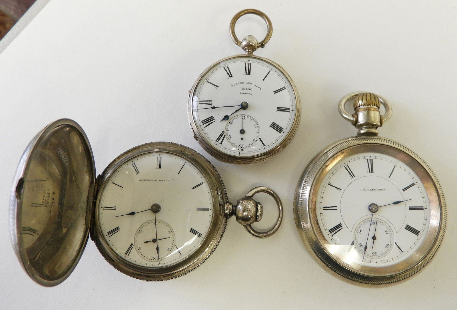 Three Silver Pocket Watches: J. H. WASHBURN SILVER & NICKEL GENT’S POCKET WATCH Open face polished silver and nickel case, white enamel dial stamped “J. H. Washburn”, black Roman numerals, seconds subsidiary dial, screw off