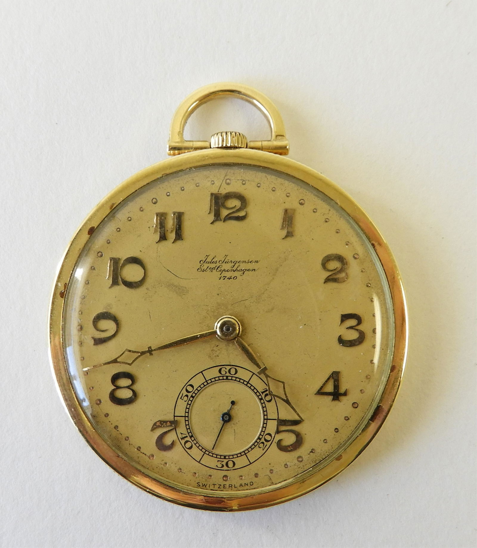 Jules Jurgensen 18K Yellow Gold Pocket Watch: Open face black enamel Delta Kappa Epsilon fraternity insignia polished 18k yellow gold case, golden dial stamped “Jules Jürgensen / Ested. Copenhagen / 1740 / Switzerland”, raised yellow gold Ar