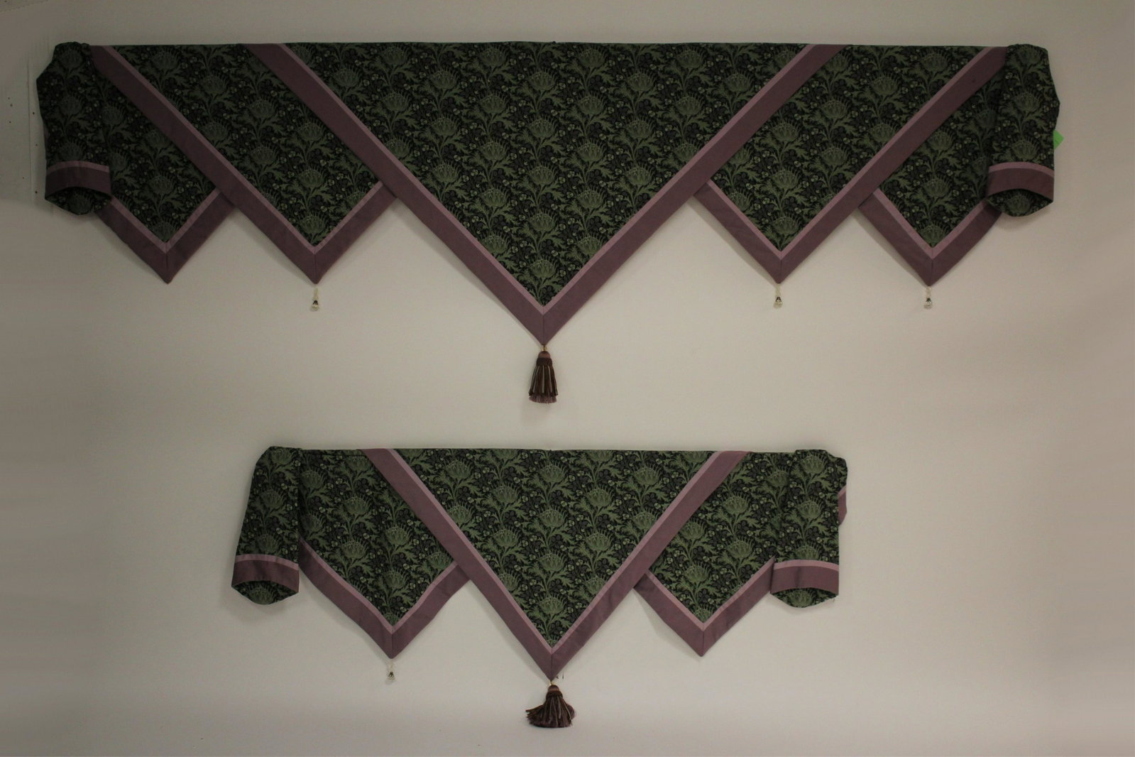 2 Matching English Arts & Crafts Style Pelmets: Window or wall treatments with fabric in a thistle pattern and complementary borders. Beaded drop pendants, center tassels. Dimensions: 97" x 39 & 56.5 x 30