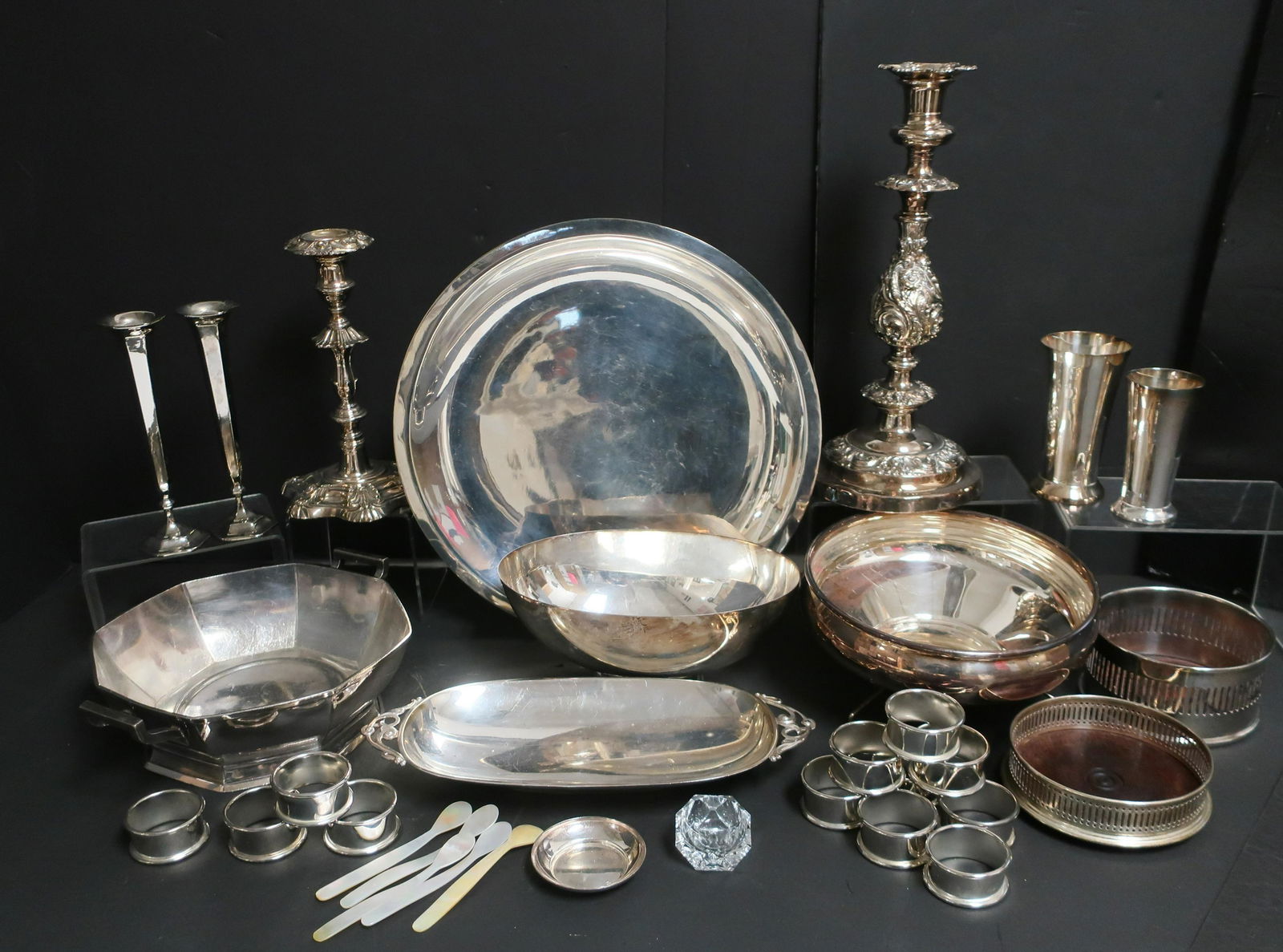 Collection of Silverplate: Collection of Silverplate, includes candlesticks, wine coasters, napkin rings, vases, bowls and trays. Approx. 26 pc. Dimensions: Largest candlestick 13" H x 5 1/2" Dia. Largest circular tray 2" H x 1