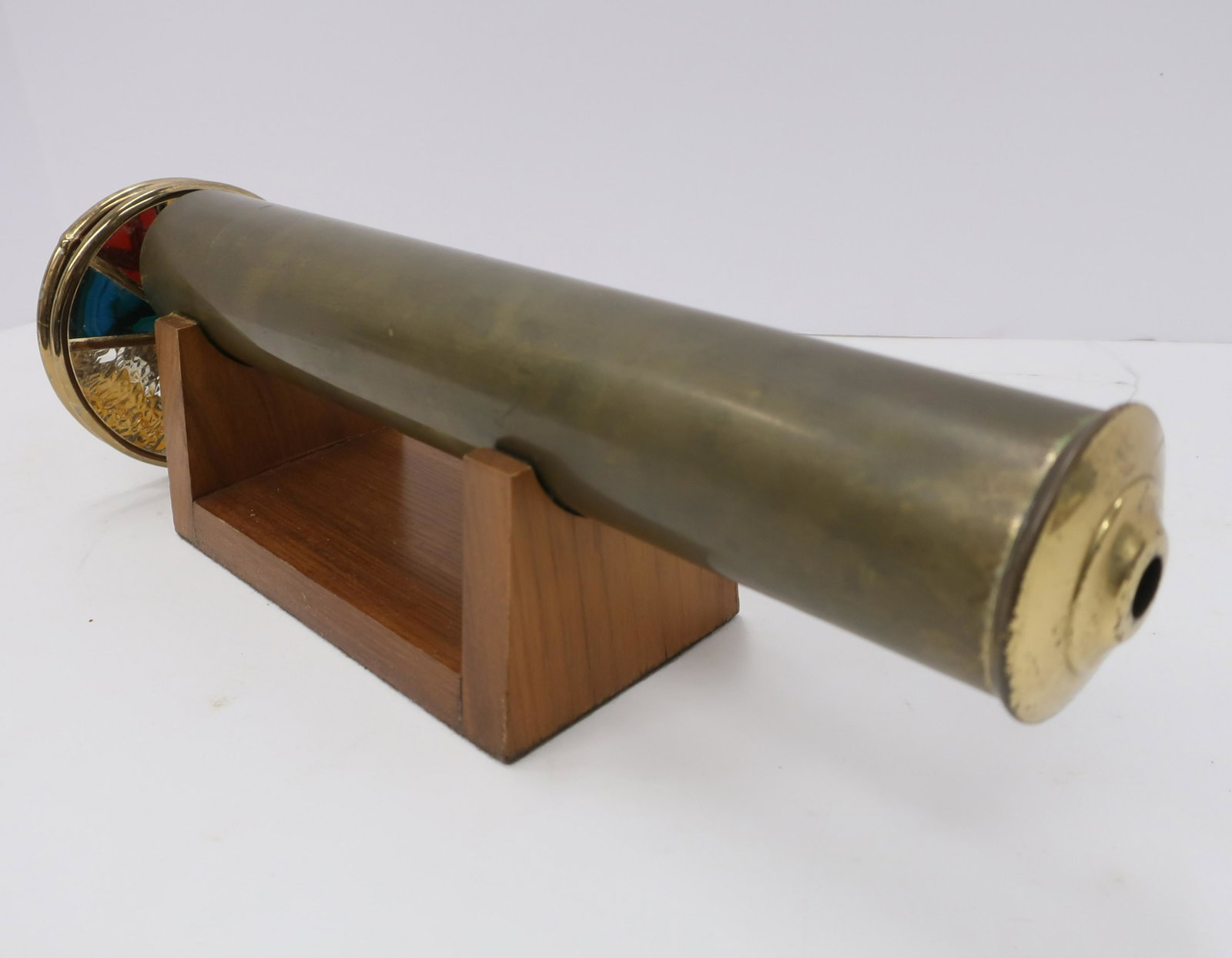 Classic Brass Kaleidoscope: Colored glass. On wood stand. Signed on eye end "Mucul__ Dimensions: 13"L (QDRIC159)(JP)