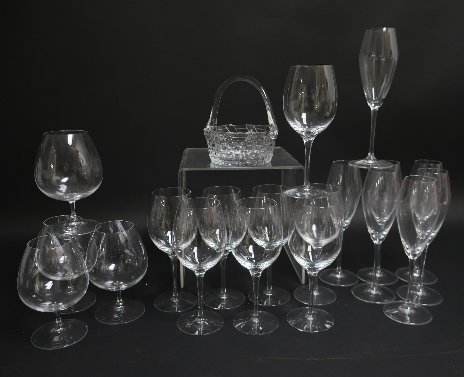 20 Clear Glasses, incl. Riedel, Orrefors: 20 Clear Glasses, includes a basket, 7 marked Riedel, 8 by Orrefors (20 pc.) Dimensions: Tallest 10" H (EBAZ1073/20)(WT)