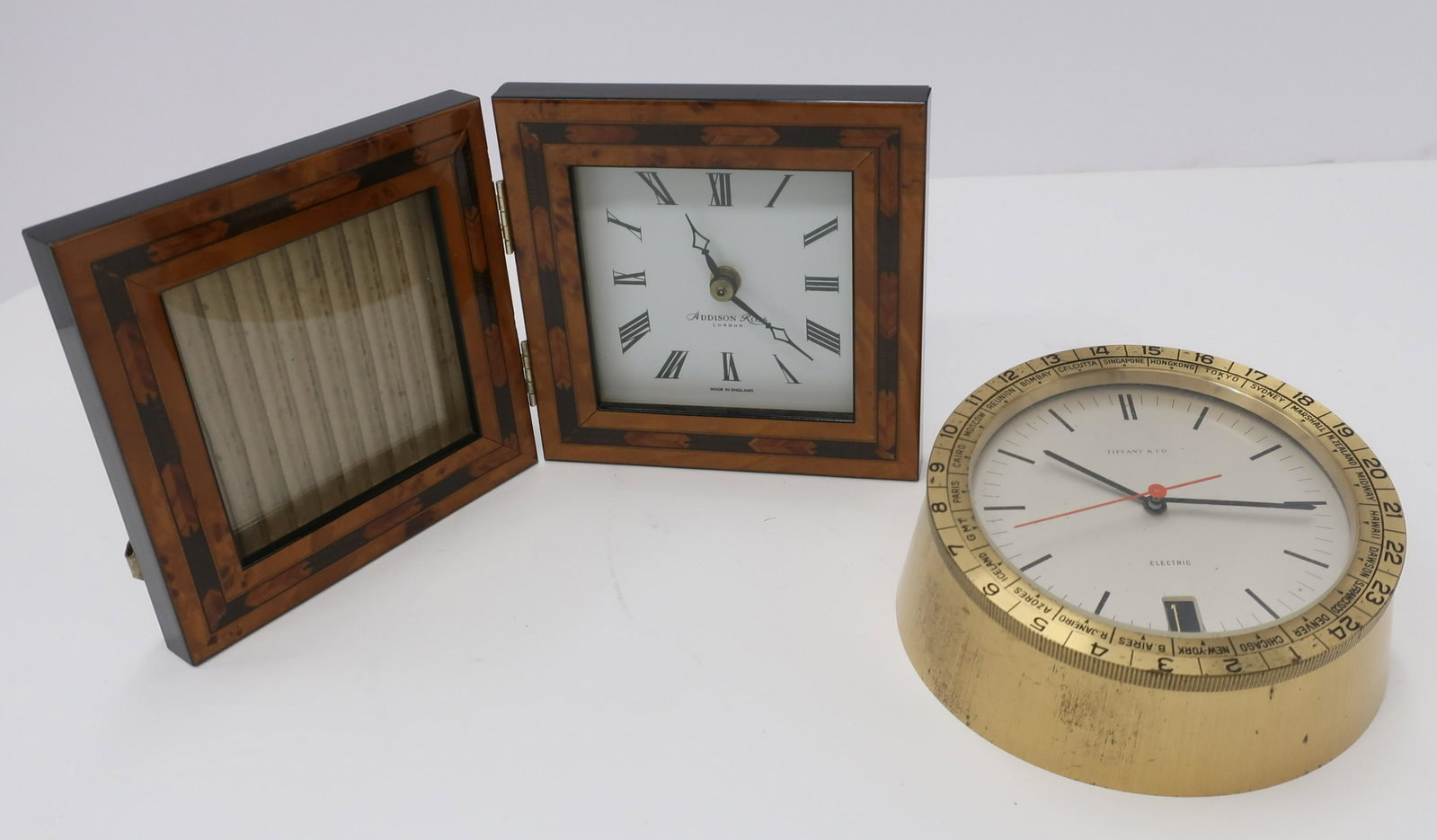 2 Clocks/Photo Frame, Tiffany & Co.: 2 Clocks/Photo Frame, brass Tiffany & Co. and Addison Ross London; Tiffany with date aperture (2 pc.) Dimensions: (QSHER1112/2)(WT)