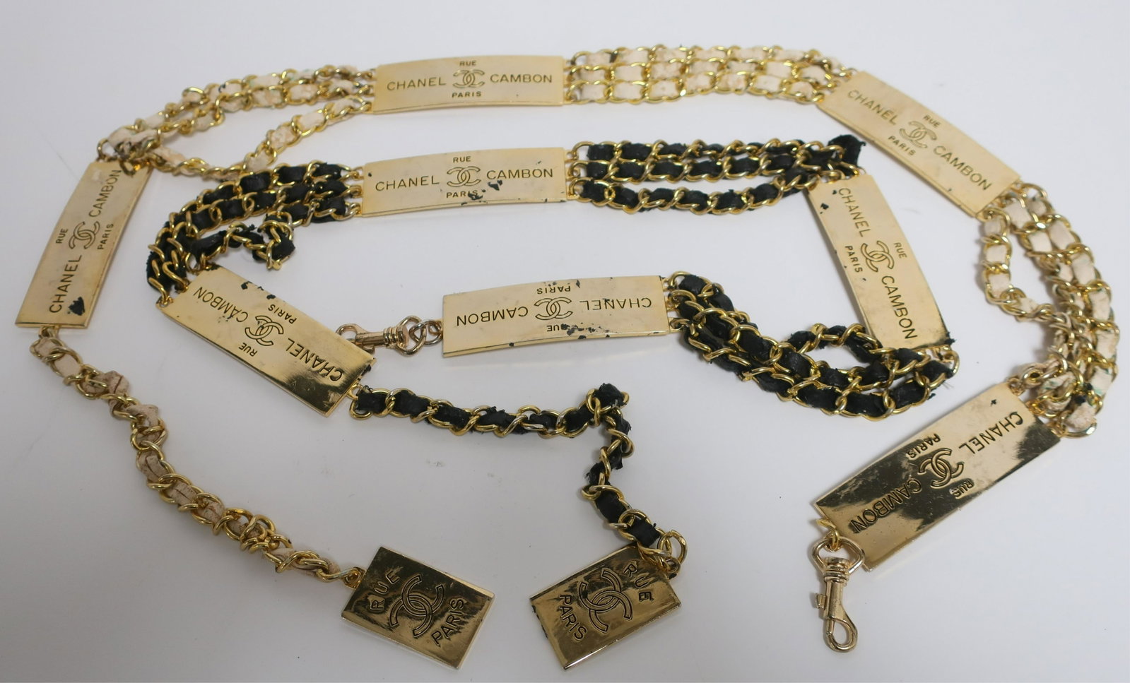 Two Chanel Cambon Belts: Black and white leather inside chain. Dimensions: Measures 40" end to end and adjustable size. Each is panel is 2" x 4" (LCA300)(EL)