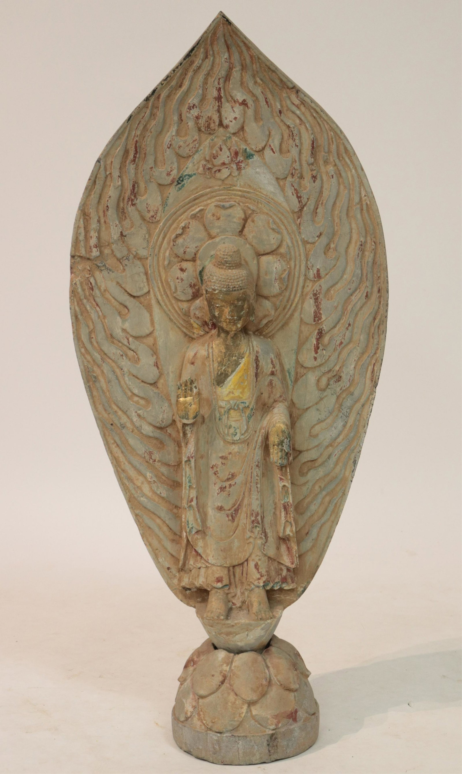 Northern Wei Style Stone Buddha: Wonderfully carved in figure with the gentle curves, the pleated garments spreading out in a fishtail fashion, and the abyhaya and varada mudra hand gestures that are all typical of the Northern Wei s