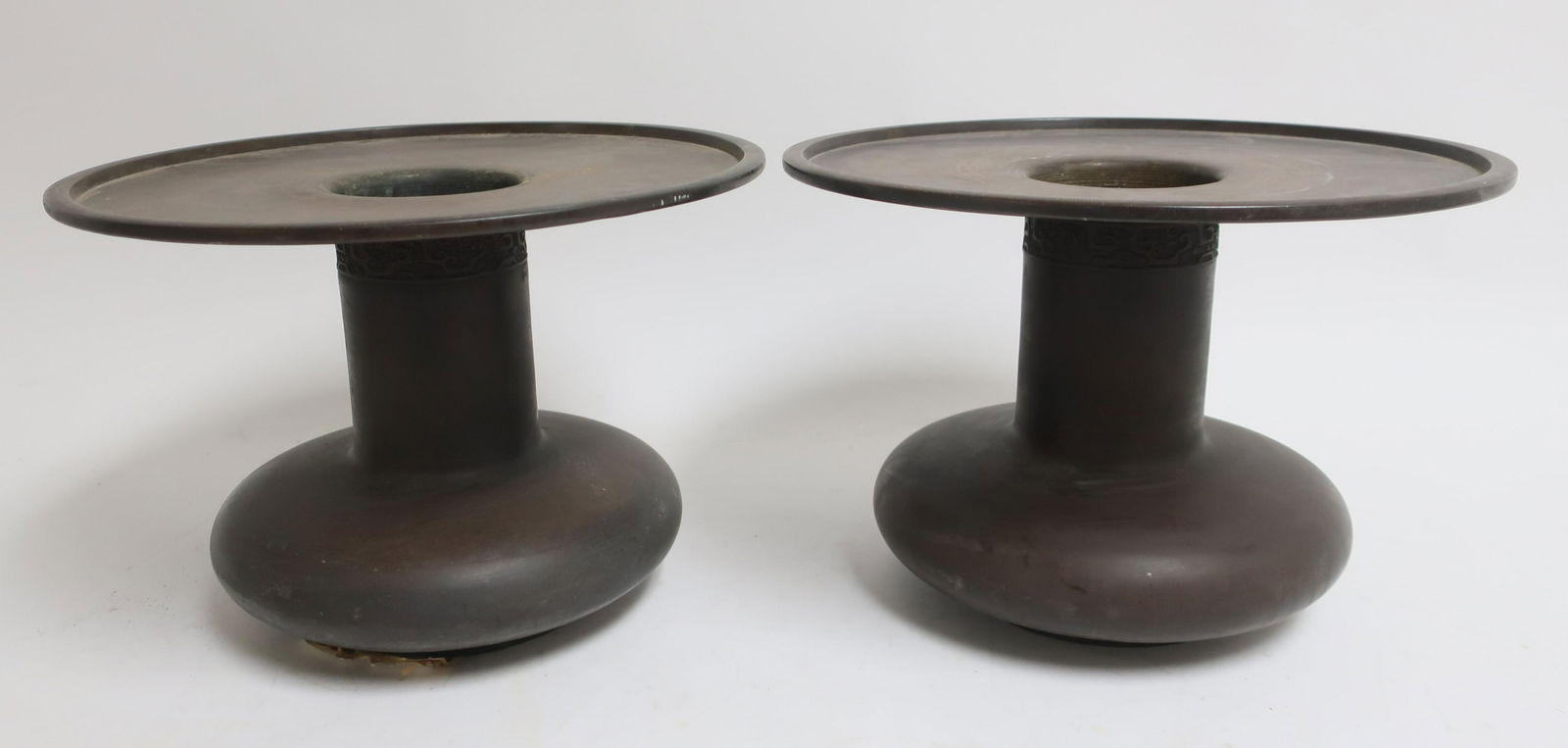 Pair Chinese Bronze Vessels: Matching bronze vases with large flat rims and low compressed bodies under a cylindrical neck. Each has a band of archiastic designs high on the neck. Four character marks on the bottom. (ROND2-722)(P