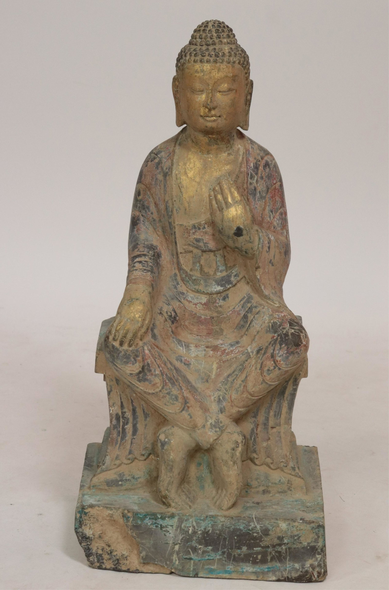 Seated Stone Buddha: Well carved seated Buddha with robes and legs crossed in the Northern Wei style. A pleasing patina of paint and gilt applied to the surface. (ROND2-775)(PR) Dimensions: 27" high