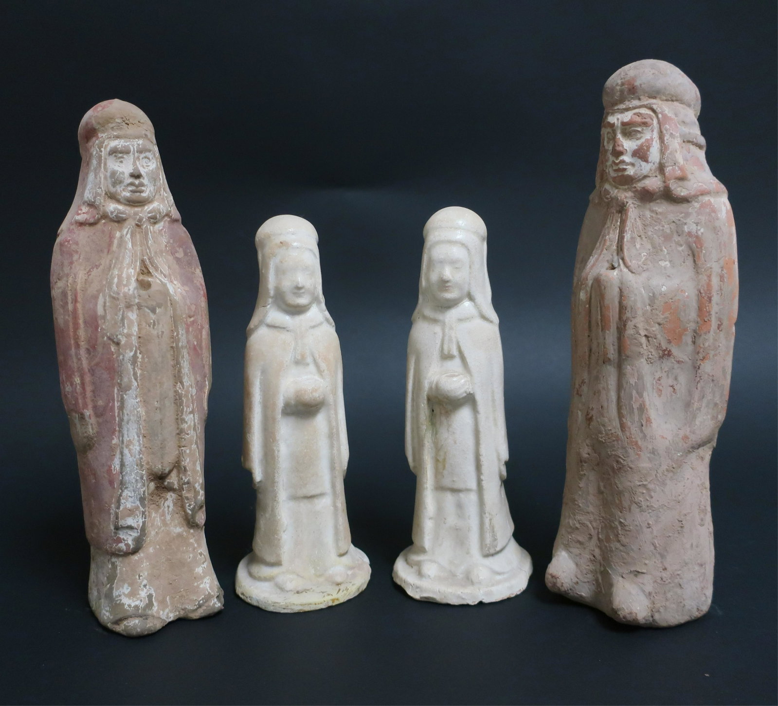 Pair of Northern Wei Guardians: Two of well molded terracotta with traces of polychrome pigment on slip and finely formed faces. The hands protruding from the robe have holes that would have held a spear or other object. Two smaller