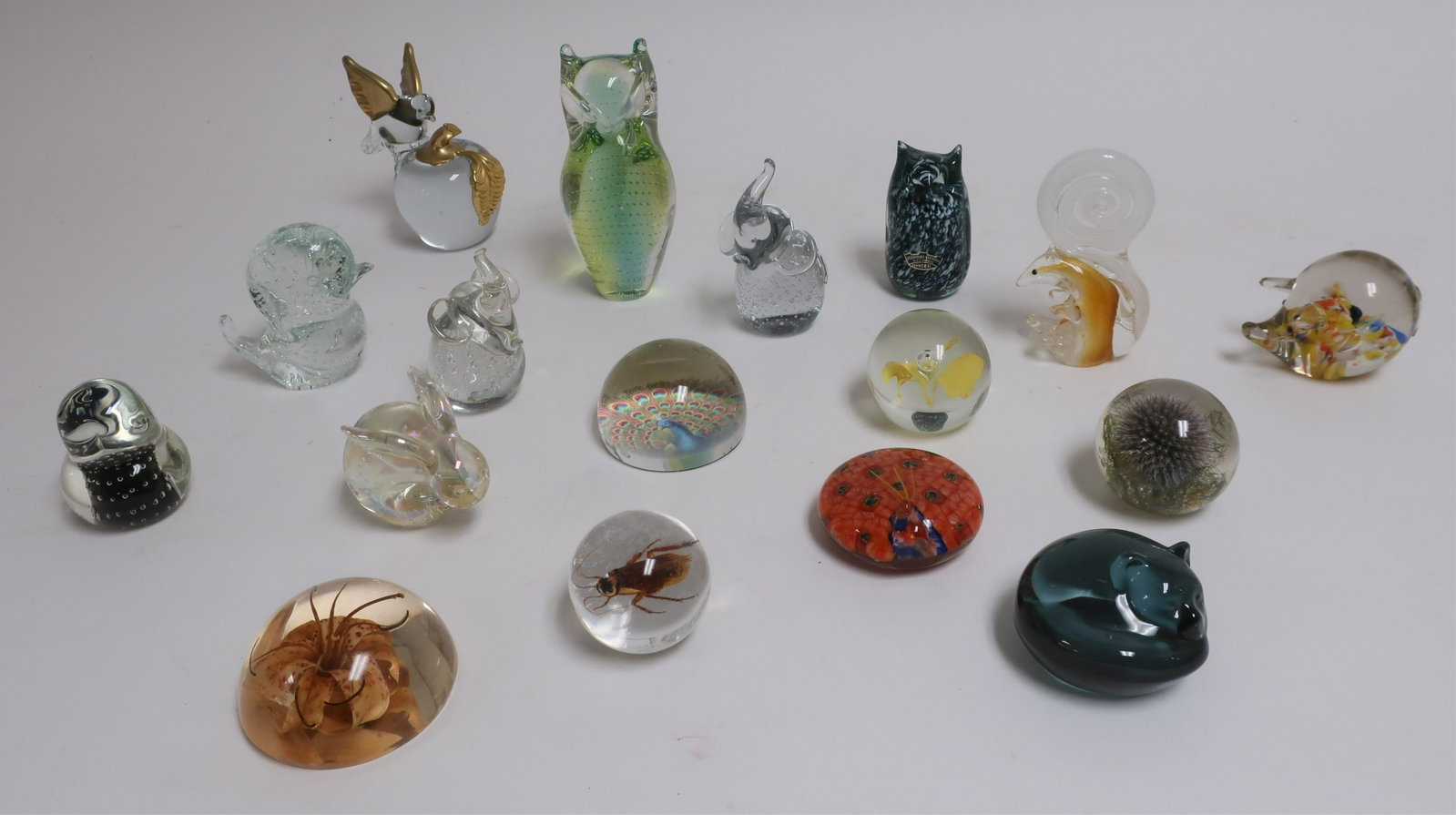 NaturePaperweights in Glass, Acrylic: Squirrel, pig, two clear with bubbles elephants, bird on apple, owl with controlled bubbles, cat, orchid in glass, thistle, insect, orchid in acrylic, Stockholms/Skansen owl, others. (SARO2987/17)(JP)