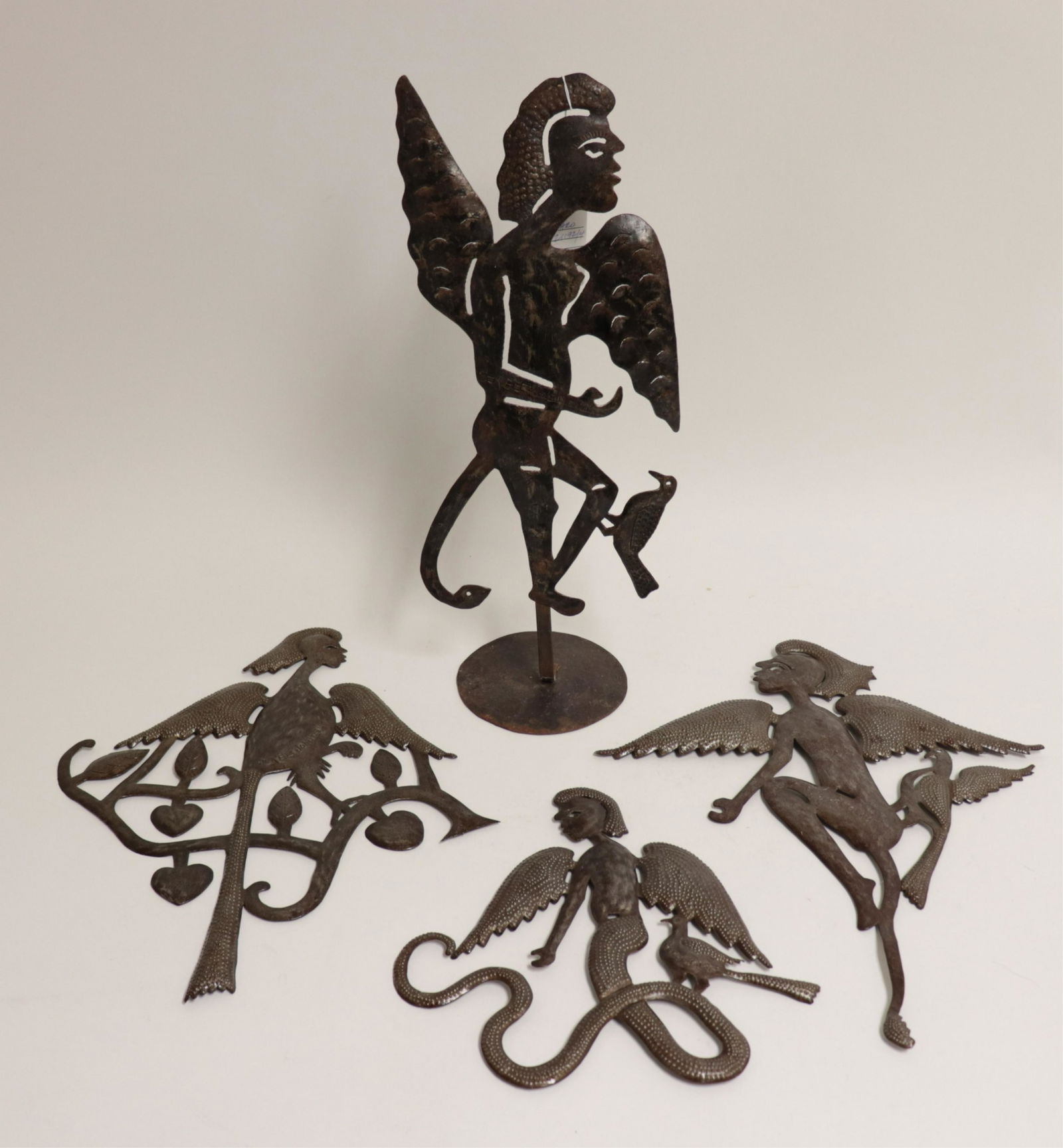 4 Serge Jolimeau (b.1952) Figural Metal Sculptures: Winged figure with bird on a stand, figural serpent forms.Cut-out sculptures with punch work and other metalwork decoration. Varnish sealed surfaces. (SARO21192/4)(JP) Dimensions: 12"L, 18.25L x 15W,