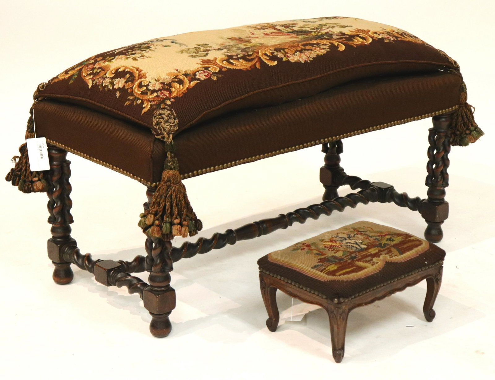 English Bench & Stool with Needlework: English Bench with needlework pillow top and twist turned walnut supports, together with a French Provincial foot stool with needlework top (2 pc.) (DORI2554/2)(WT) Dimensions: 20" H x 36" L, 7" H x 1