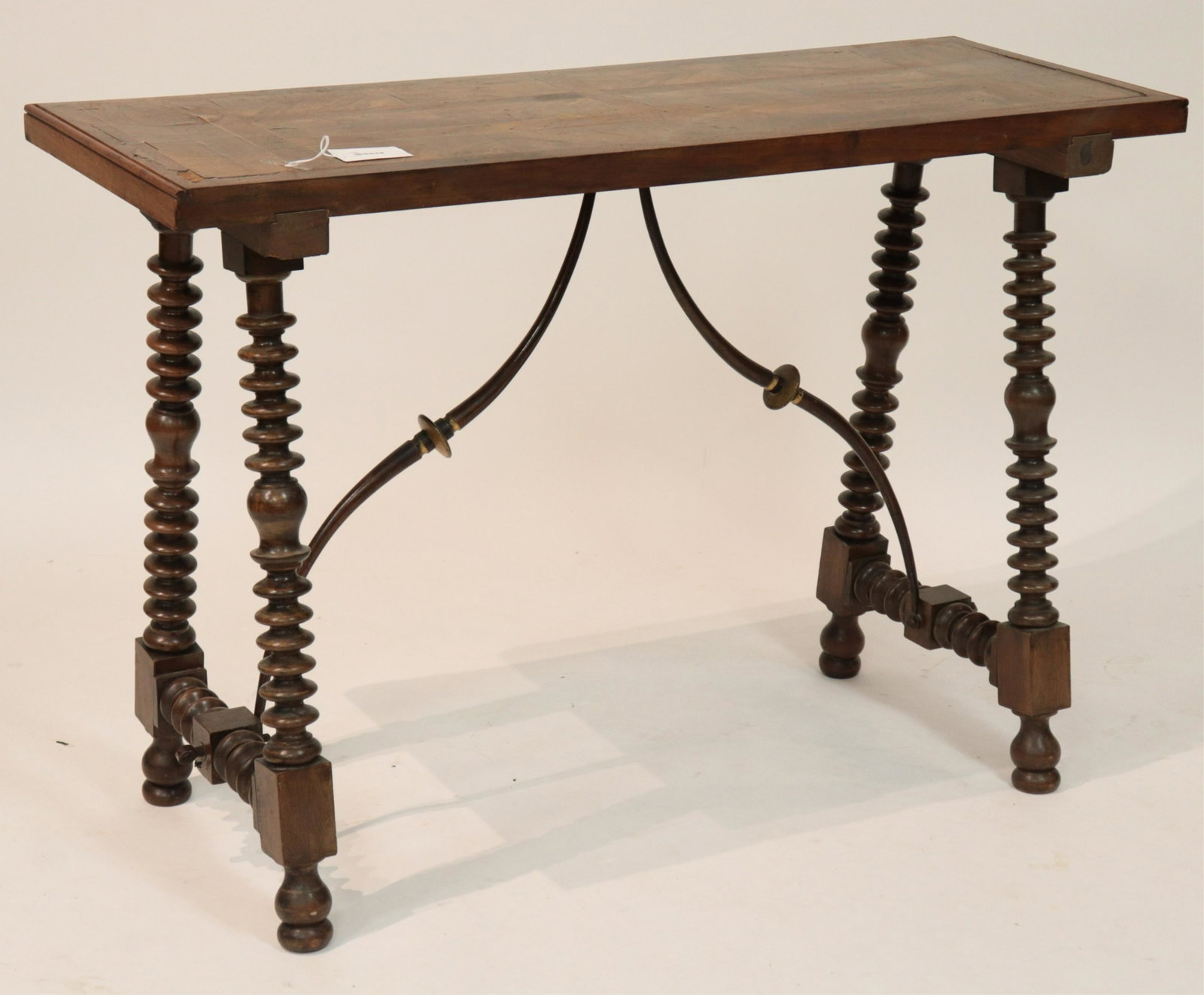 Antique Continental Inlaid Console Table: Walnut veneers. Rectangular inlays to top. Spool turned legs and shaped cross stretchers. S form metal stretchers. Threaded tensioners for bracing stretchers. Painted antiqued faux bois and gilt finis