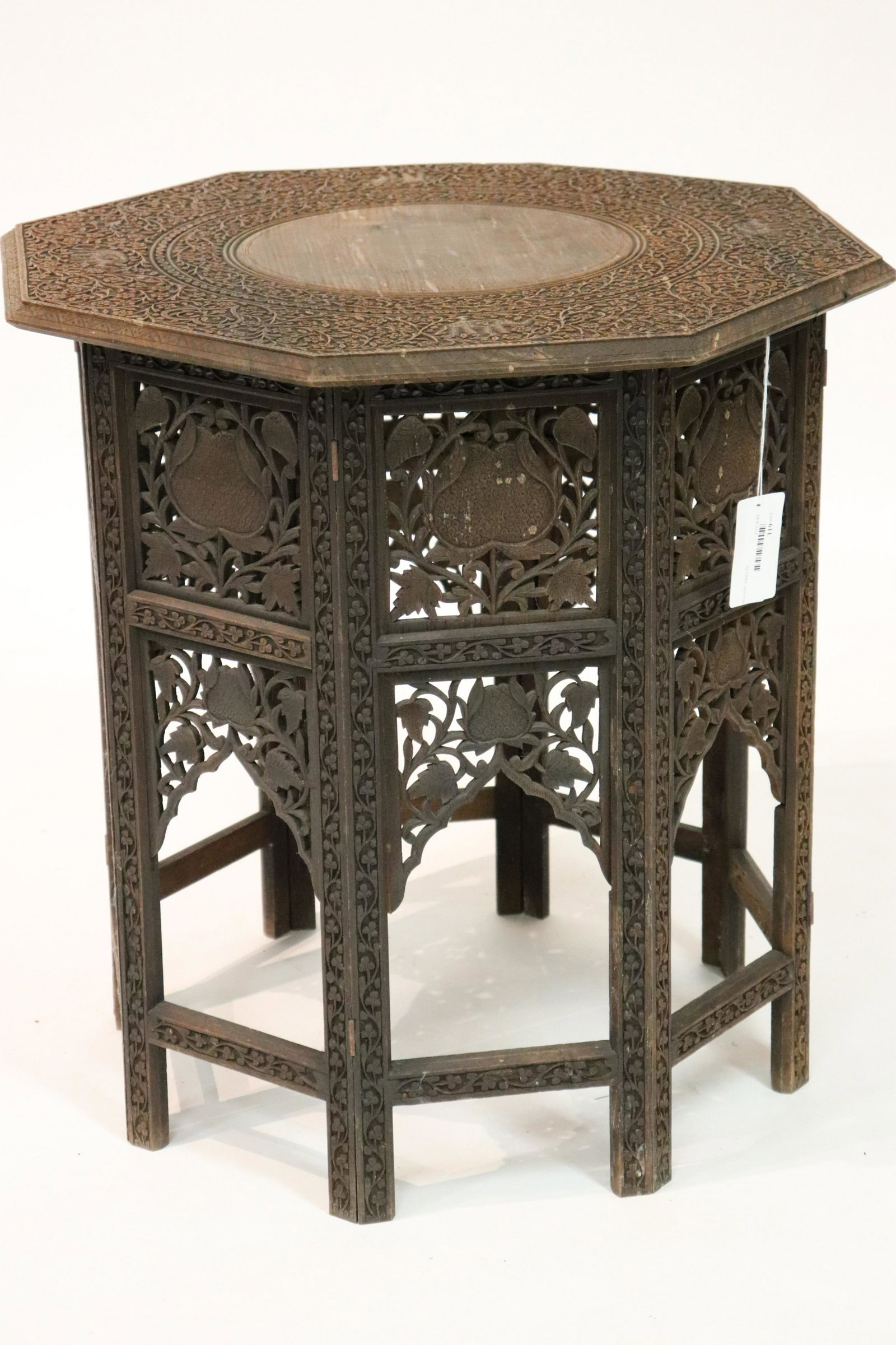 Ornately Carved Indian Teak Table: Ornately Carved Octagonal Indian Teak Table, base hinged for folding, brass inlay in diamond pattern (SJAM2611)(MM) Dimensions: 25 x 25