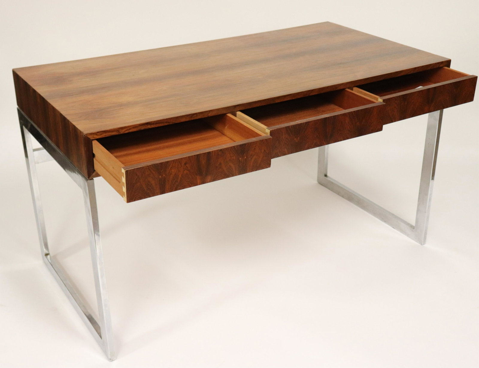 Milo Baughman - Rosewood on Chrome Writing Desk: Three drawer writing surface on chrome base by Milo Baughman. (FLO506)(EL) Dimensions: 29.25 H x 52 W x 26 D