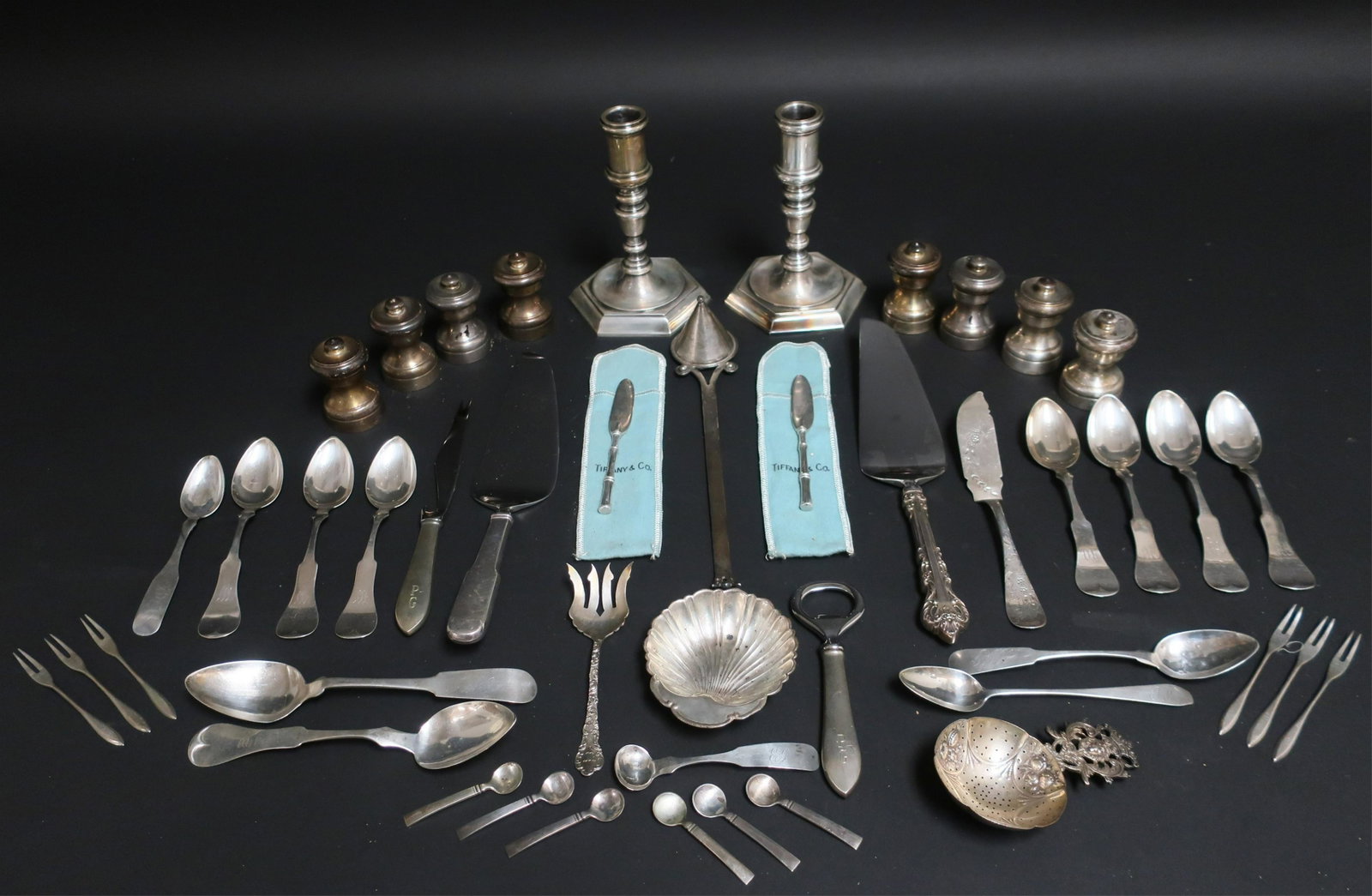 Group of Sterling, Coin and .800 Silver: Group of Sterling, Coin and .800 Silver, includes 6 Georg Jensen salt spoons, 2 Tiffany butter spreaders, pair .835 hexagonal candlesticks, .925 tea strainer with lion mask handle, etc., some monogram