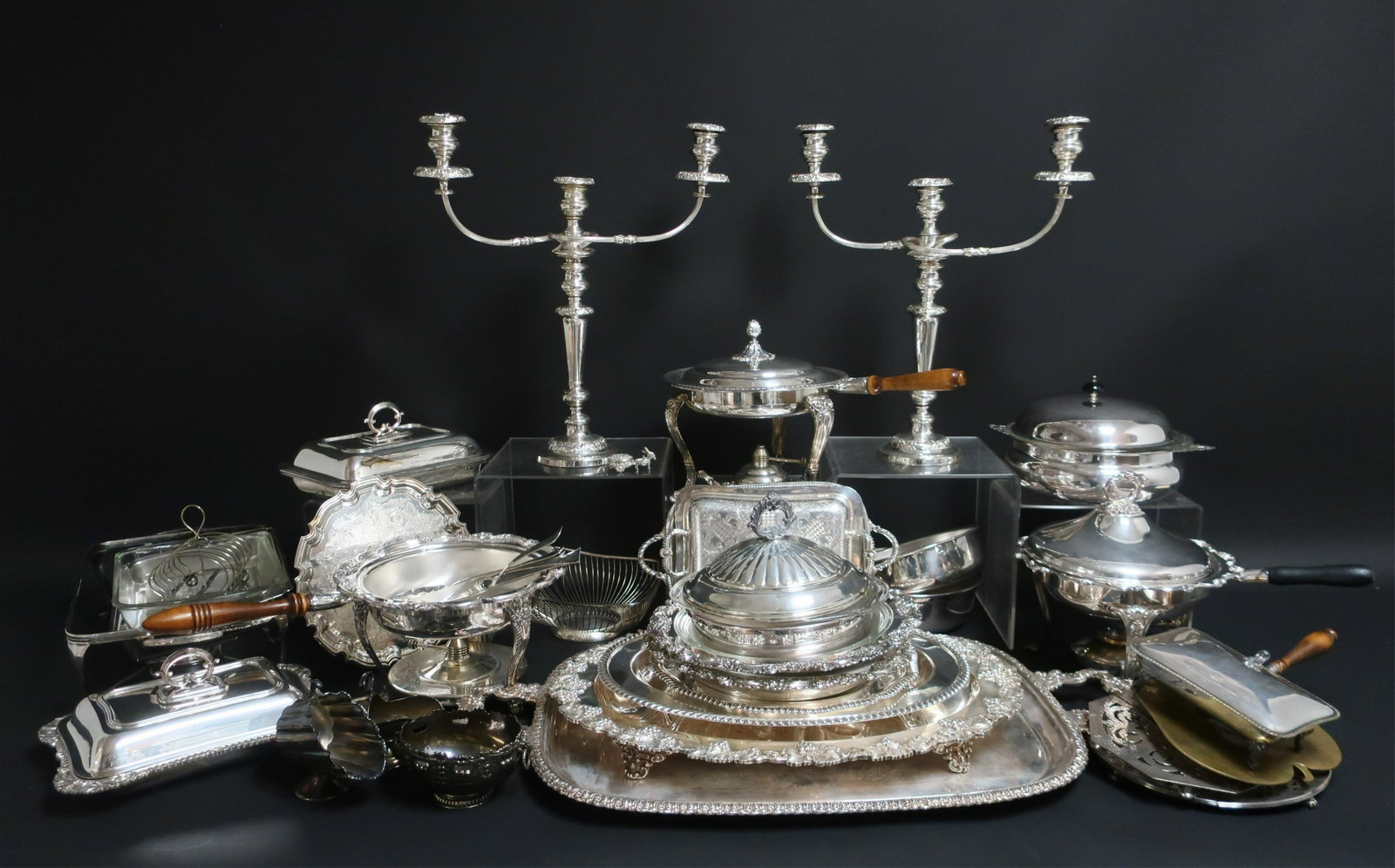 Large Group of Silverplate Items: Large Group of Silverplate, mostly trays, chafing dishes, casserole stands with spirit burners, vegetable dishes, pair large 3-light candelabra (lot) (DORI2930/lot)(WT) Dimensions: Longest tray 32", C