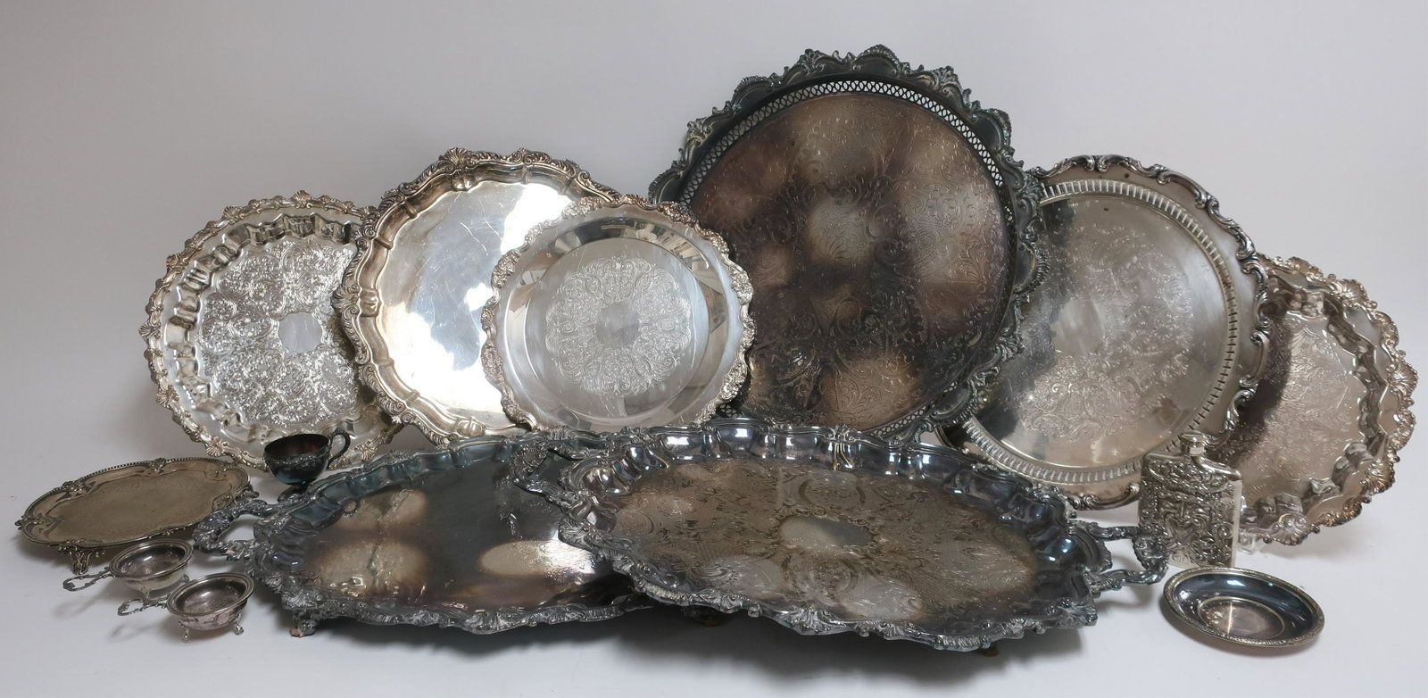 10 Silverplate Trays, Tiffany & Co.: 10 Silverplate Trays, the smallest by Tiffany & Co., 2 tea strainers with stands, a cup and a flask (14 pc.) (DDBR2538/14)(WT) Dimensions: Tiffany 5 1/2" dia., largest 28"