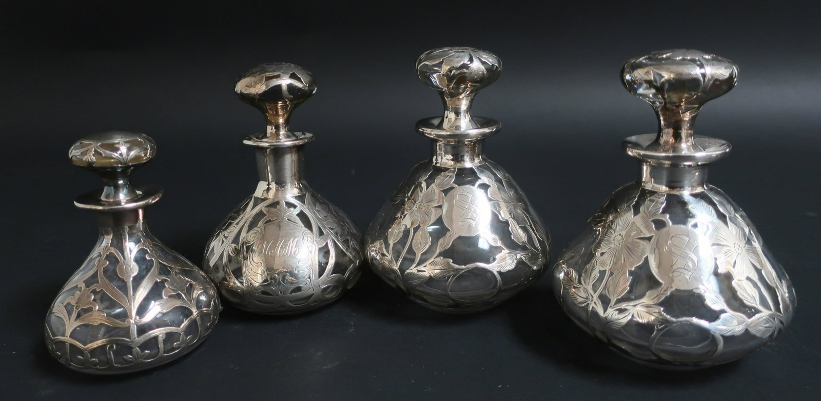 4 Sterling Silver Overlay Clear Glass Perfumes: 4 Sterling Silver Overlay Clear Glass Perfumes, one Alvin 3119-9, 999/1000, 5 1/2" H x 4" Dia.; one Gorham D927 with tiny 3/8" loss to silver band, 4 1/2" H x 3" Dia.; and one with sterling silver mar