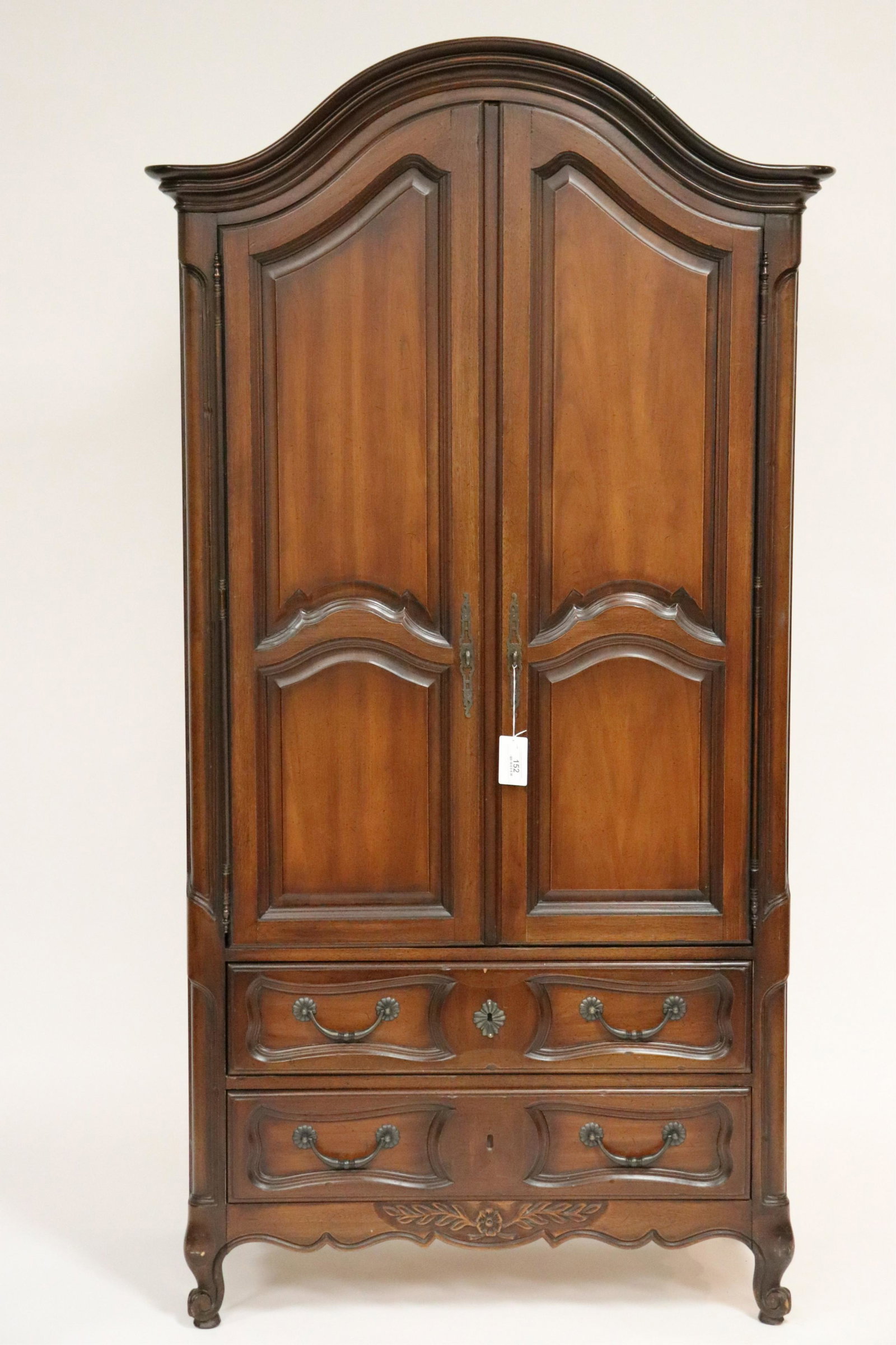 Arched Bonnet Armoire by Drexel: Two doors, two lower drawers. Interior top shelf and four drawers with shaped hand pulls. Shaped front corners, raised panel shaped doors, sides, drawers. Full length decorative door hinges. Antiqued 