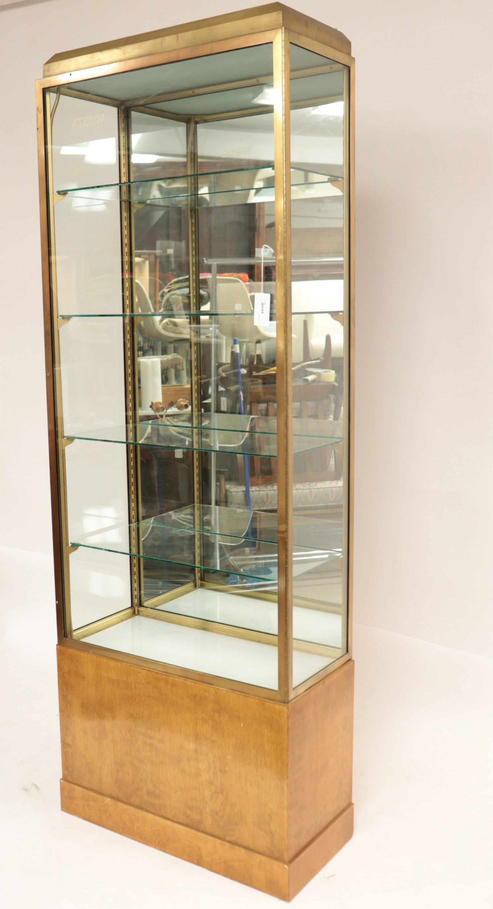 70's Brass & Birch Veneered Display Cabinet: (NJWA94)(MS) Dimensions: 84" H x 29 1/2" W x 14" D Property from the Estate of an Important New York Modernism Dealer.