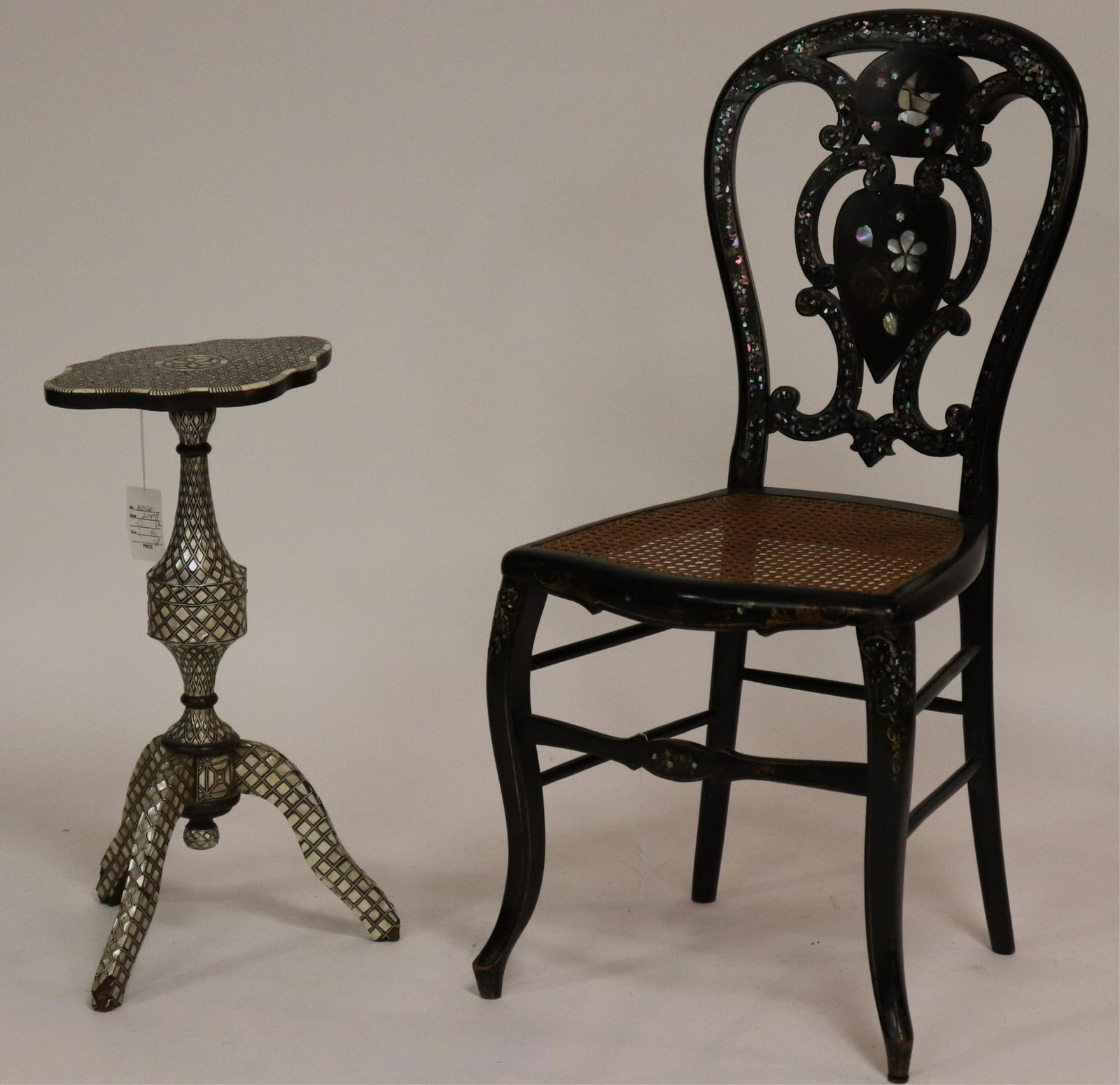 Inlaid Indo-Persian Table and a Side Chair: M.O.P. and bone inlaid on wood tripod table along with a M.O.P. black painted balloon back side chair, caned seat; sits steady. NOTE: This lot is being reoffered due to nonpaying bidder Eitan Dor of C