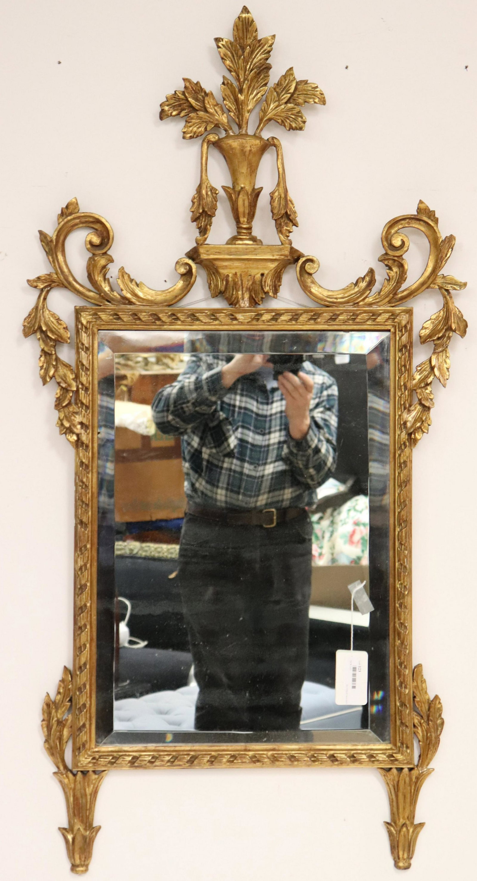 LXVI Style Giltwood Mirror: Scrolled and leafed elements. Vase on plinth with fronding/branched peak. Beveled glass mirror. Dimensions: 48.5"H x 25W (QINP6123)(JP)