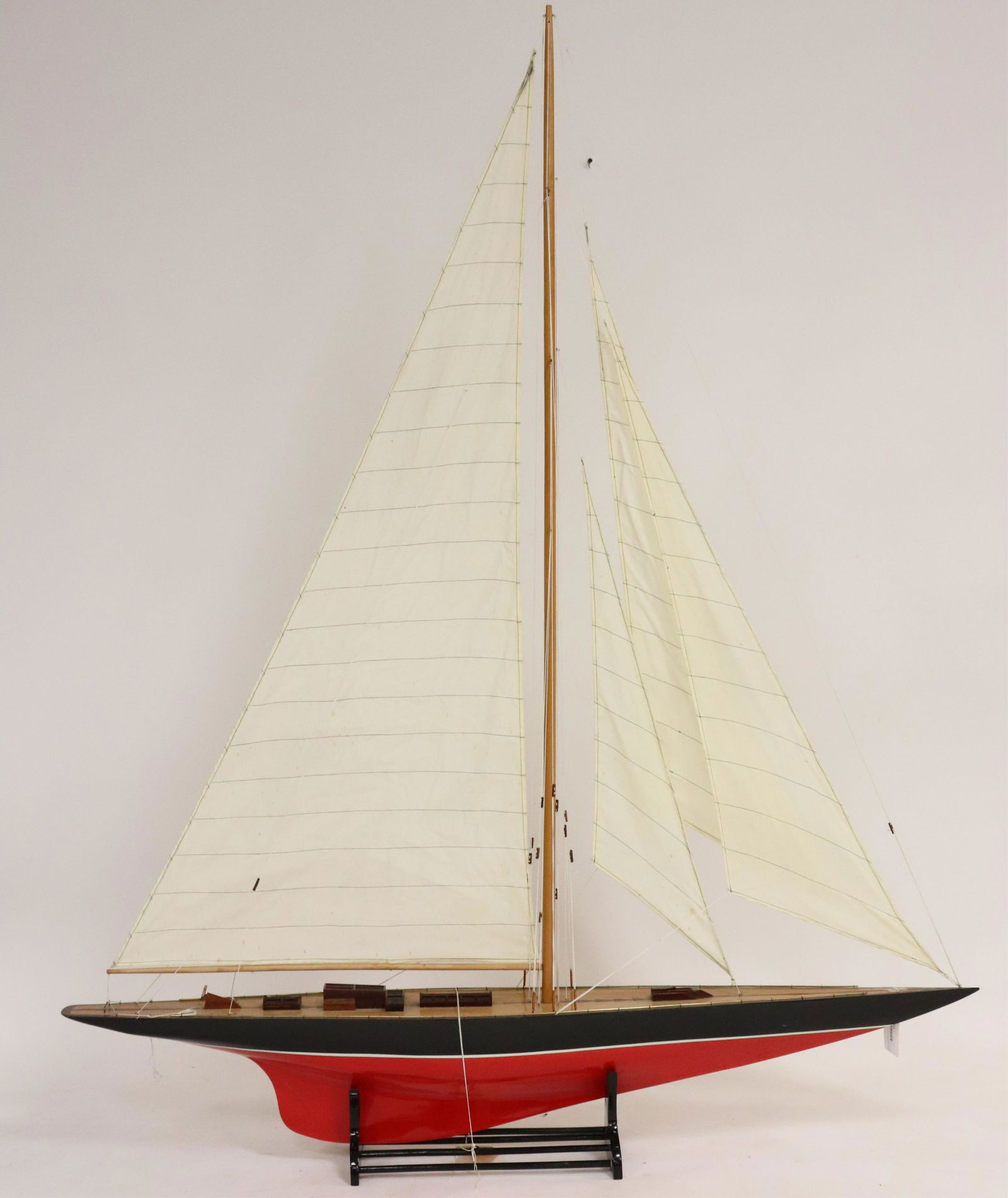 Model of a Red & Black Painted Sailboat on Stand: Model of a Red & Black Painted Sailboat on Stand Dimensions: 72 1/4" H including stand, 58" (ELB594)(MS)