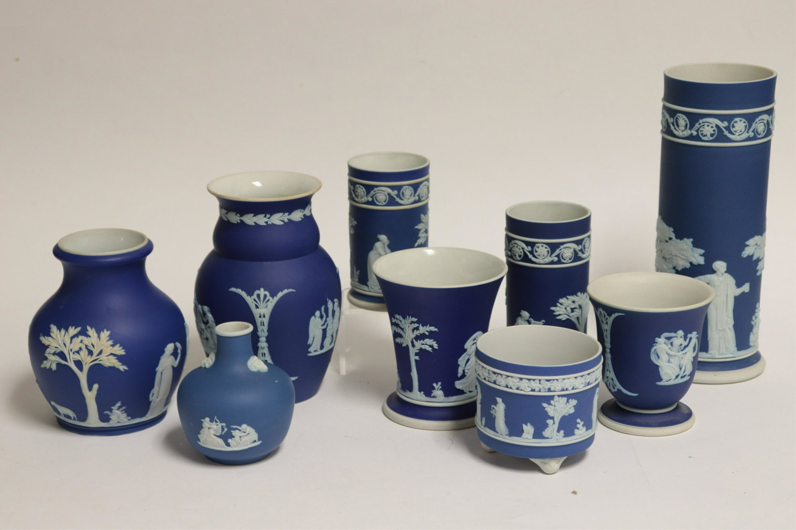 9 Wedgwood Blue Jasper Dip Vases: 9 Wedgwood Blue Jasper Dip Vases, 6 marked Made in England, 1 Wedgwood England (9 pc.) Part II from a major collection of Wedgwood, Long Island, NY Dimensions: 8 1/4" H cylindrical impressed mark, 5" 