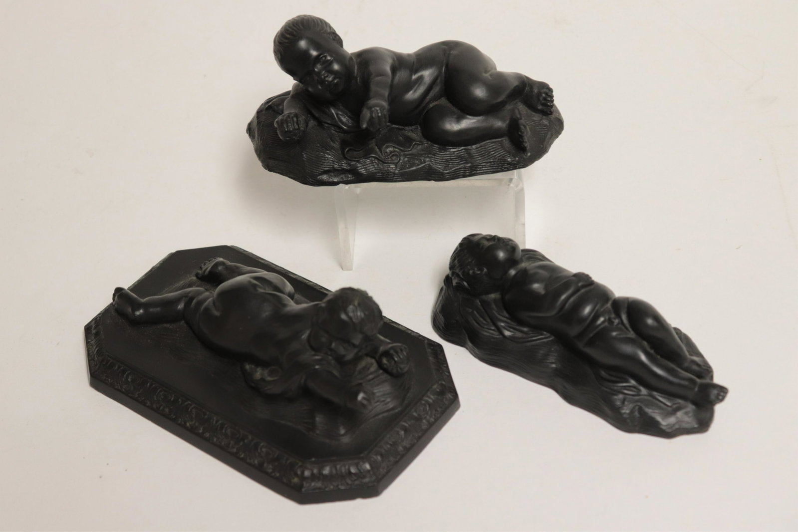 3 Wedgwood Black Basalt Reclining Babies: 3 Wedgwood Black Basalt Reclining Babies, all with impressed mark, 2 retain tags from Skinner Auctions, sold Boston on 7/15/2006 and July 14, 2007 (3 pc.) Part II from a major collection of Wedgwood, 