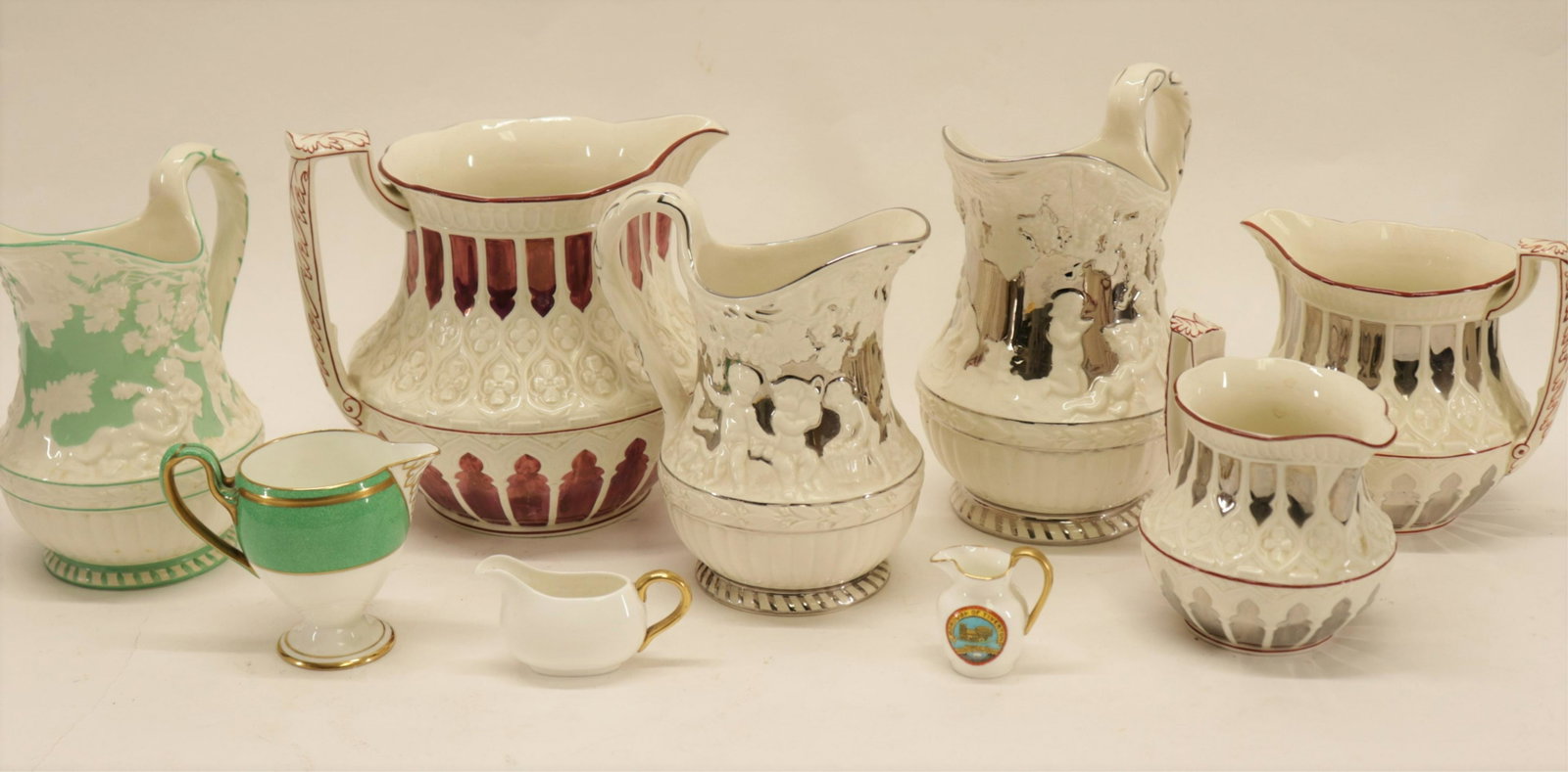 9 Assorted Wedgwood Pitchers: 9 Assorted Wedgwood Pitchers, some lustre, various printed, impressed marks and Made in England marks (9 pc.) Part II from a major collection of Wedgwood, Long Island, NY Dimensions: Smallest 1 3/4" H