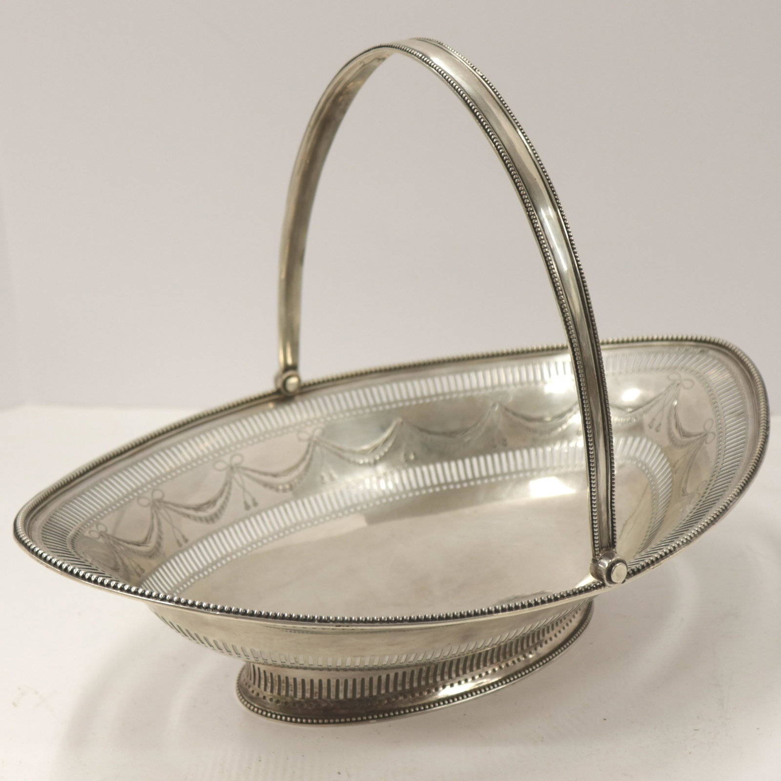 George III Silver Basket, Hougham, London, 1788: George III English Silver Oval Basket, London, 1788, Charles Hougham maker, swing handle, 23.57 ozt Dimensions: 4 1/2" H (without handle), x 14" L Property from the Estate of Florence (1917-2018) and 