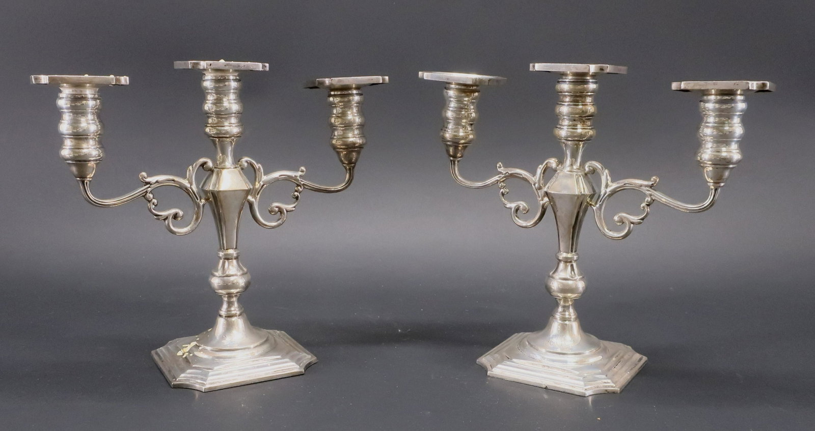 Pair American Sterling Silver 3 Light Candelabra: By Black, Starr & Gorham. Scrolling arms, baluster standards, cavetto-canted square bases and removable bobeche. Weighted bases. Marked bottoms. Engraved "MAP". Dimensions: 10.25"H x 9.25W Property fr
