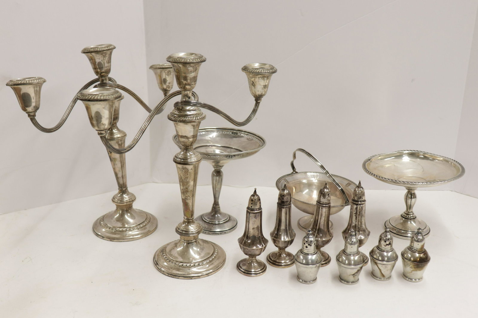 Lot of Weighted Sterling Silver: Lot of Weighted Sterling Silver, includes candelabra, tazze, salts and peppers Dimensions: Candelabra 12 1/2" H x 12 1/2" W Property from the Estate of Florence (1917-2018) and Judge David Edelstein (