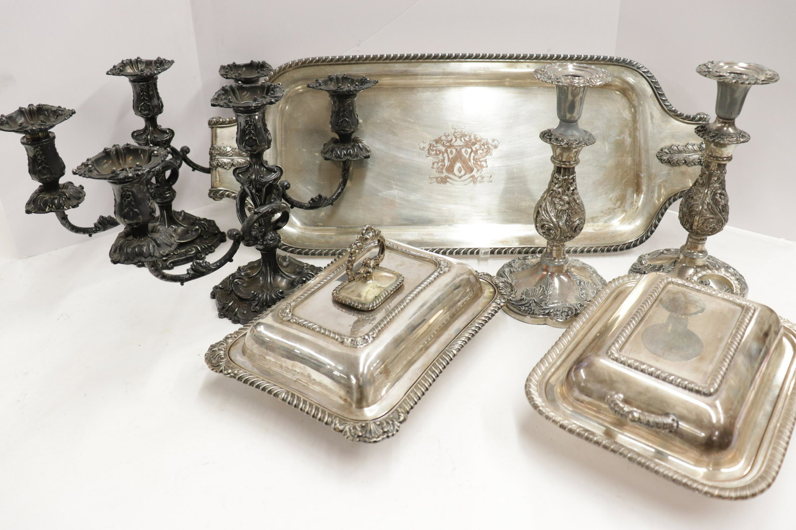 Silverplate Table Pieces, Pr. 1890 Tiffany Candelabra: Including Pair of c.1890 Tiffany & Co 3-light candelabra, one Elkington & Co covered vegetable dish, and a tray with armorial Dimensions: Tray 26.5 x 10.25, Candelabra 10 x 15.5 Property from a Park S