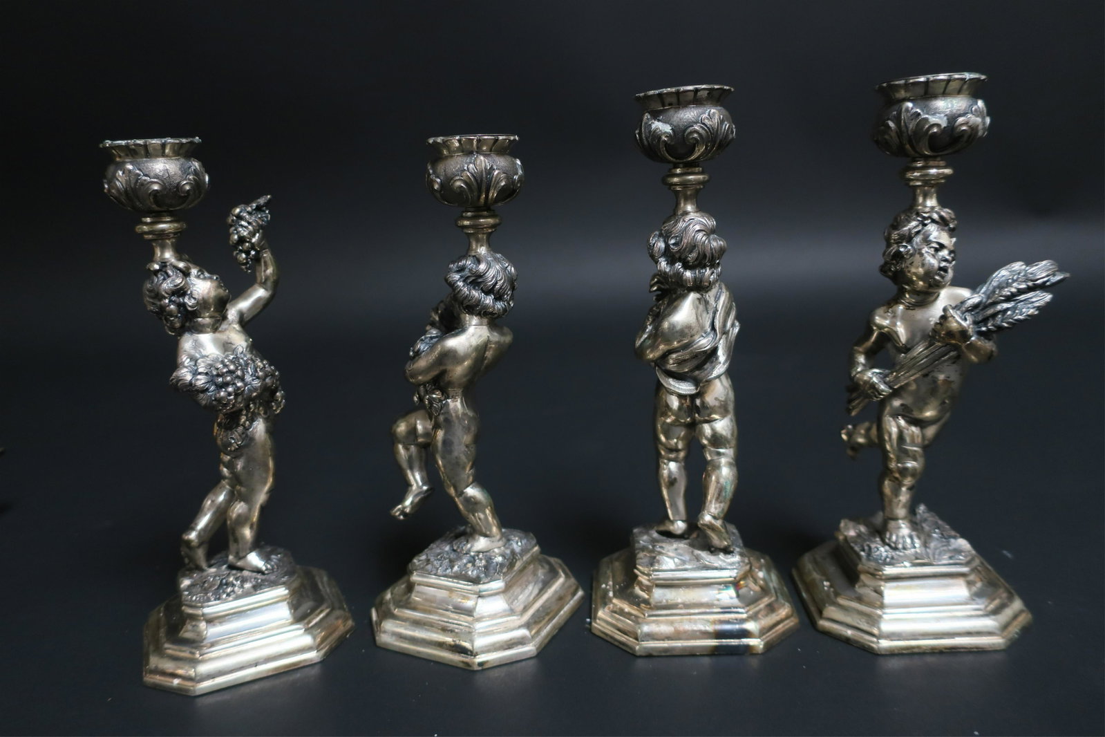 4 Silverplate Cherub Candlesticks & Additions: Set of 4 Silverplate Cherub Candlesticks, 3 tea strainers and 2 pair of knife rests. Dimensions: Sticks 7" H Property from a New York Estate (DORI2929/9)(WT)