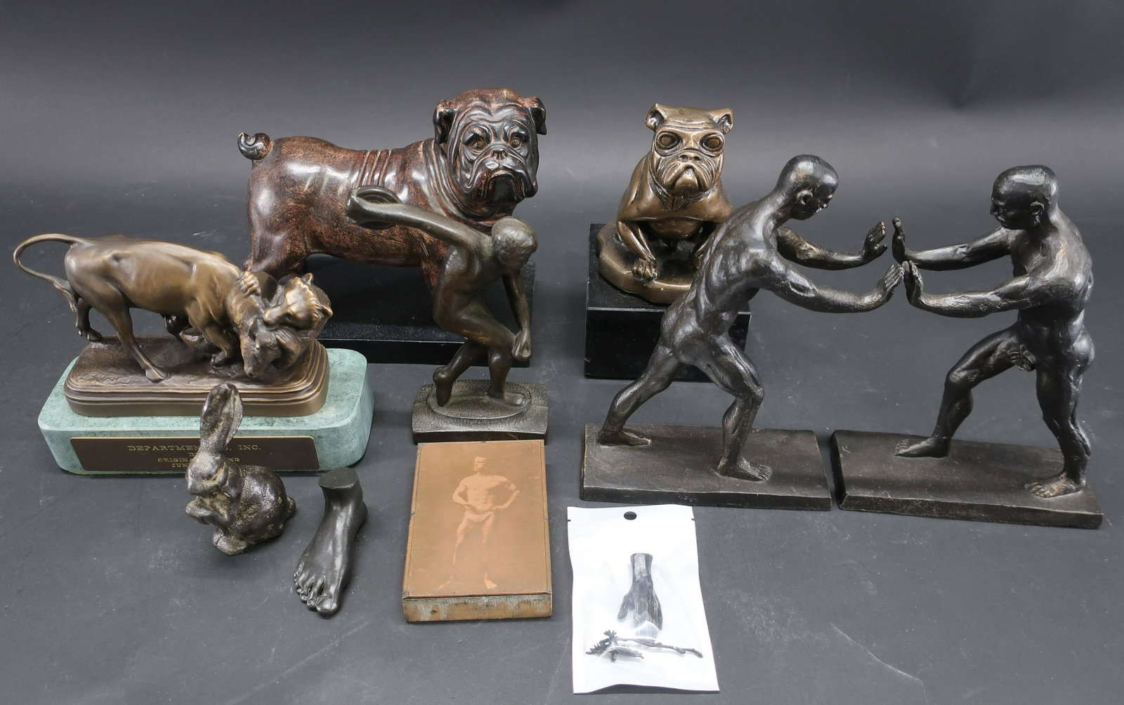 Group of 12 Small Sculptures: Group of 12 Small Sculptures, etc., includes composition dog, iron bookends, discus thrower and rabbit, bronze Dantes, foot, etc. Dimensions: 2" L to 8 1/2" H Property from the Estate of Edward Bazine