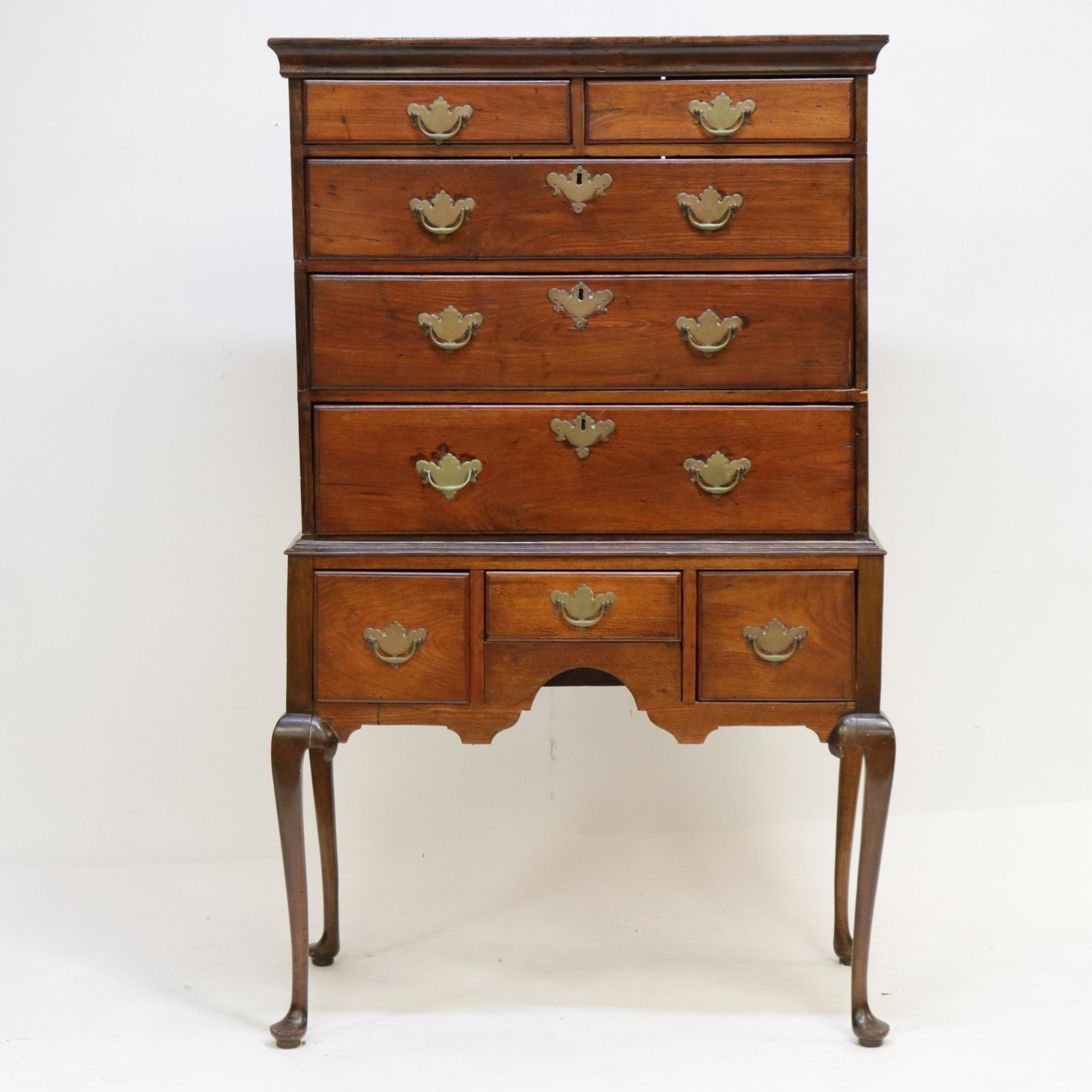 18th C. American Queen Anne Highboy: Queen Anne Style American Flat Top Highboy, 18th C., cherry with pine secondary wood, arched shaped skirt Dimensions: 61"H x 36"W x 21"D Property from a Washington, CT estate (JGOO7689)(MM)