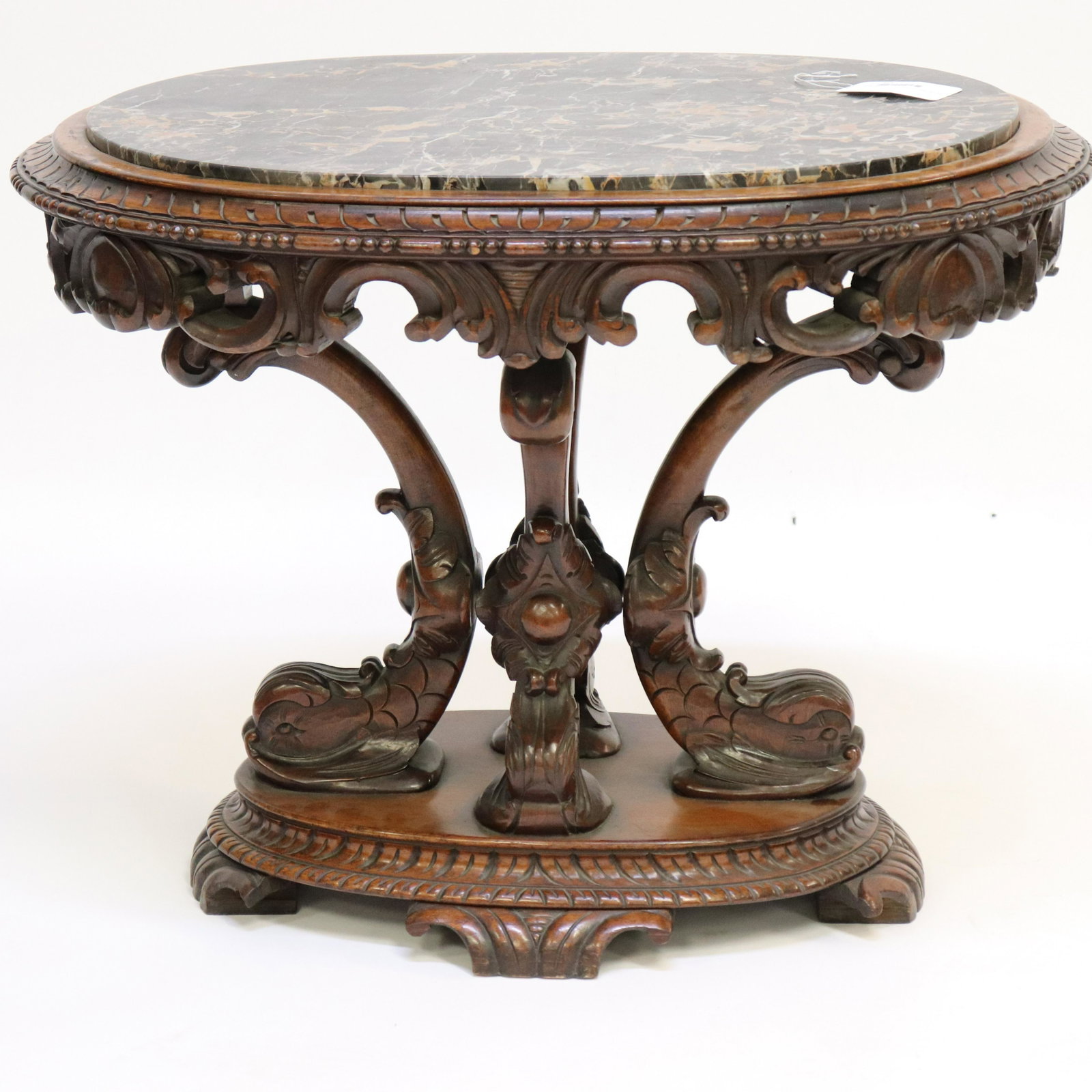 Oval Walnut Marble Top Low Table: Oval Walnut Low Table, black marble top & dolphin supports Dimensions: 21" H x 28" L Property from the Estate of Florence (1917-2018) and Judge David Edelstein (1910-2000). In 1951, President Truman a