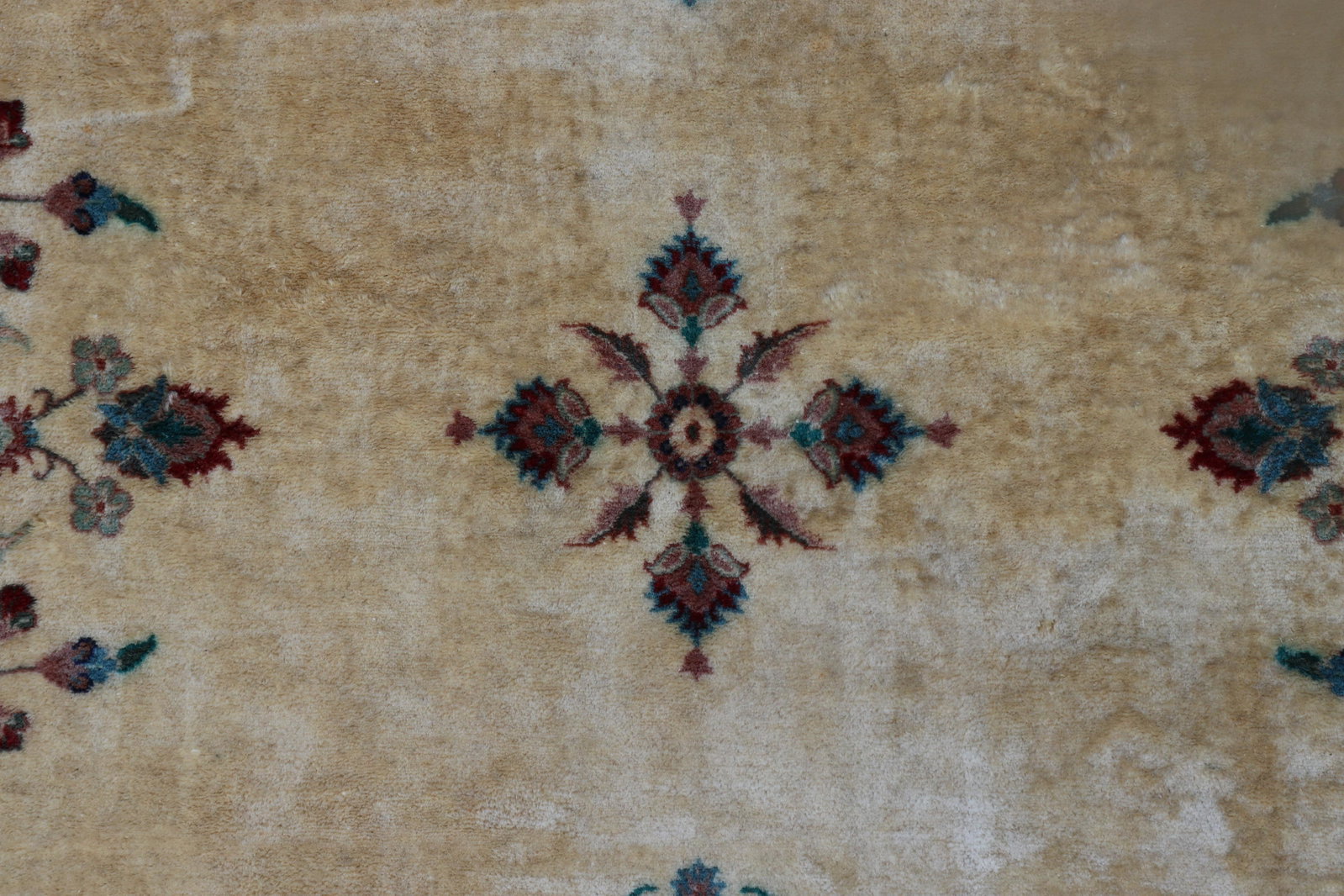 Saropy Wool Rug, Pakistan - 8 x 10: Saropy Wool Rug, made in Pakistan, verso label affixed Field of Ivory ground with band of pale green and rust ground, mirrored floral pattern throughout. Note: Purchased from Bloomingdale's, c. 1960, 