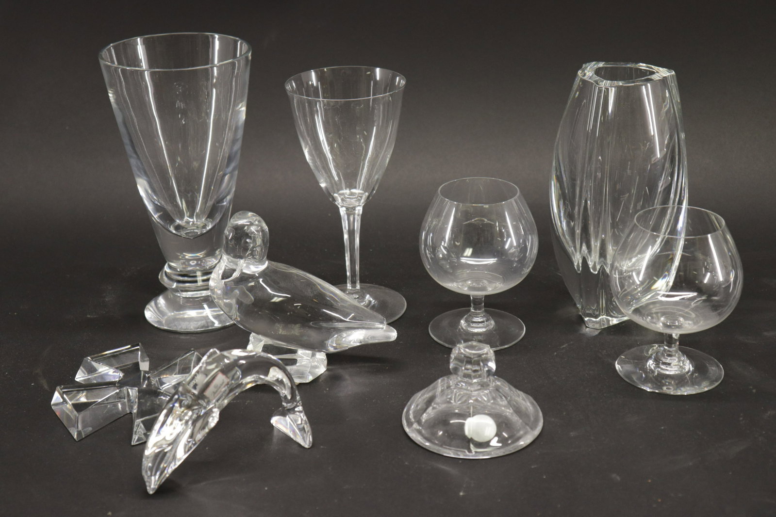 9 Pieces of Clear Baccarat Glass: Dimensions: Dolphin 3 1/4" x 4 1/4" W, Taller Vase 8 1/2" H x 4 1/2" Dia. Property from a Litchfield collection (LCA6530/9)(WT)