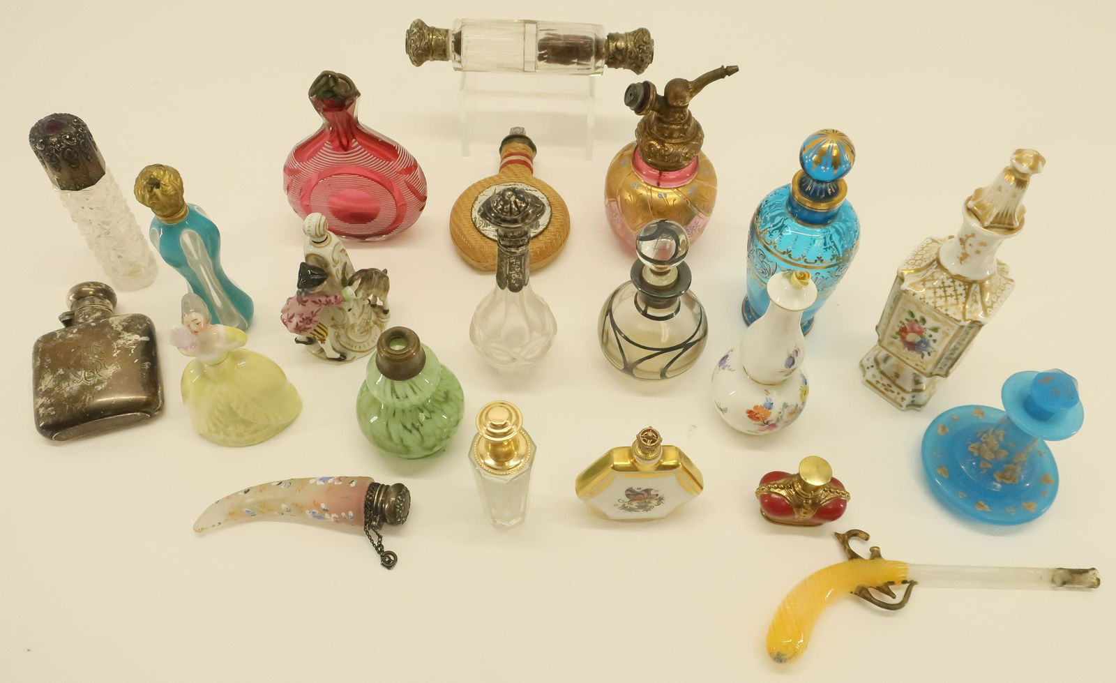 21 Mostly Glass & Porcelain Perfume Bottles: 21 Mostly Glass & Porcelain Perfume Bottles, includes: English silver flask form Capodimonte figure with goat, Meissen gourd shape, Venetian pistol form and four with silver tops Dimensions: Tallest 6