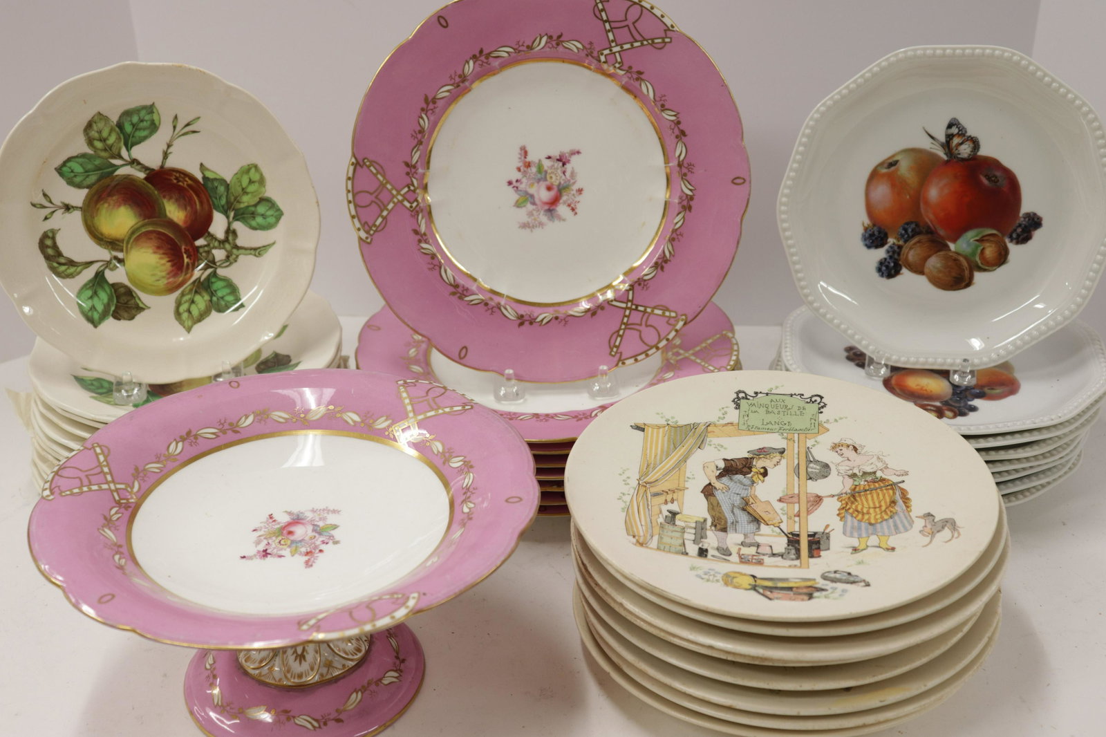 4 Sets Porcelain/Pottery Plates: 4 Sets Porcelain/Pottery Plates, comprises: 9 English with pink border, 8 French with amusing scenes, 8 Rosenthal fruit and 10 Spode oversized saucers Dimensions: Compote 4 1/2" H x 9 1/2" Dia. Proper