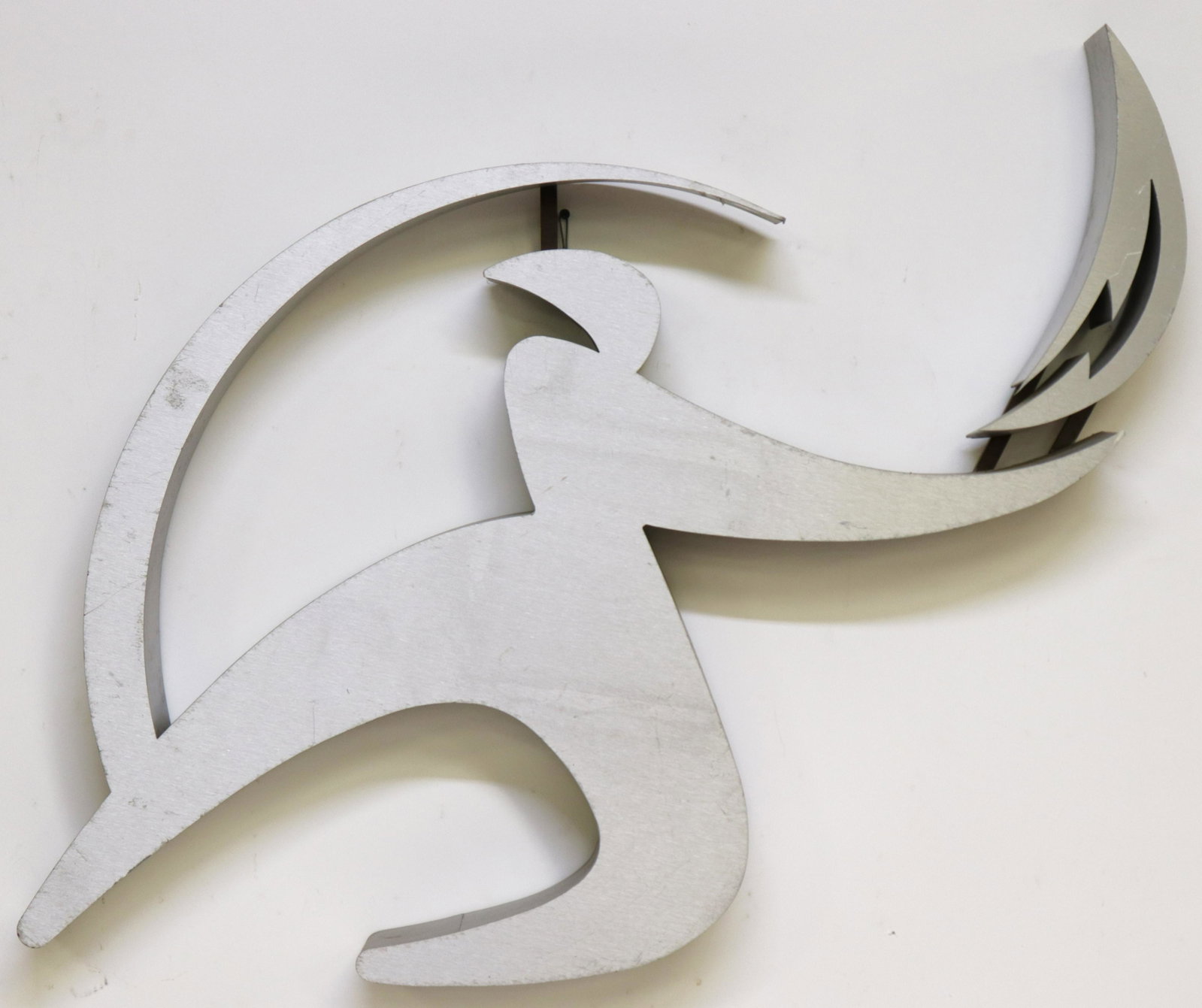 Abstract Modern Wall Sculpture: Modern Hanging Wall Sculpture, 20th C., form of a figure holding lightning bolt, brushed aluminum, unsigned Dimensions: 30 1/2 x 31 x 3 Property from a Roxbury, CT residence (JLOM7688)(MM)