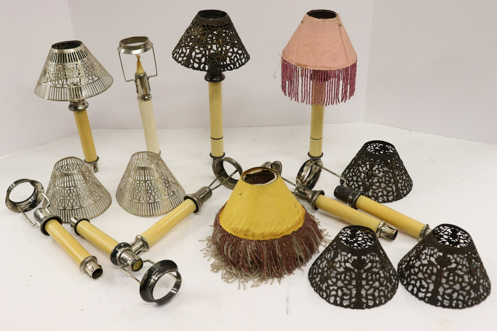 Lot of Silver & Other Candle Fixtures: Lot of Candle Fixtures, comprises: 7 silver shades in 2 styles, 7 beaded shade liners, and 9 silverplate candle shade holders. Silver 11.5 ozt Dimensions: Silver shades approx. 3 1/2" H x 8 1/4" dia.,
