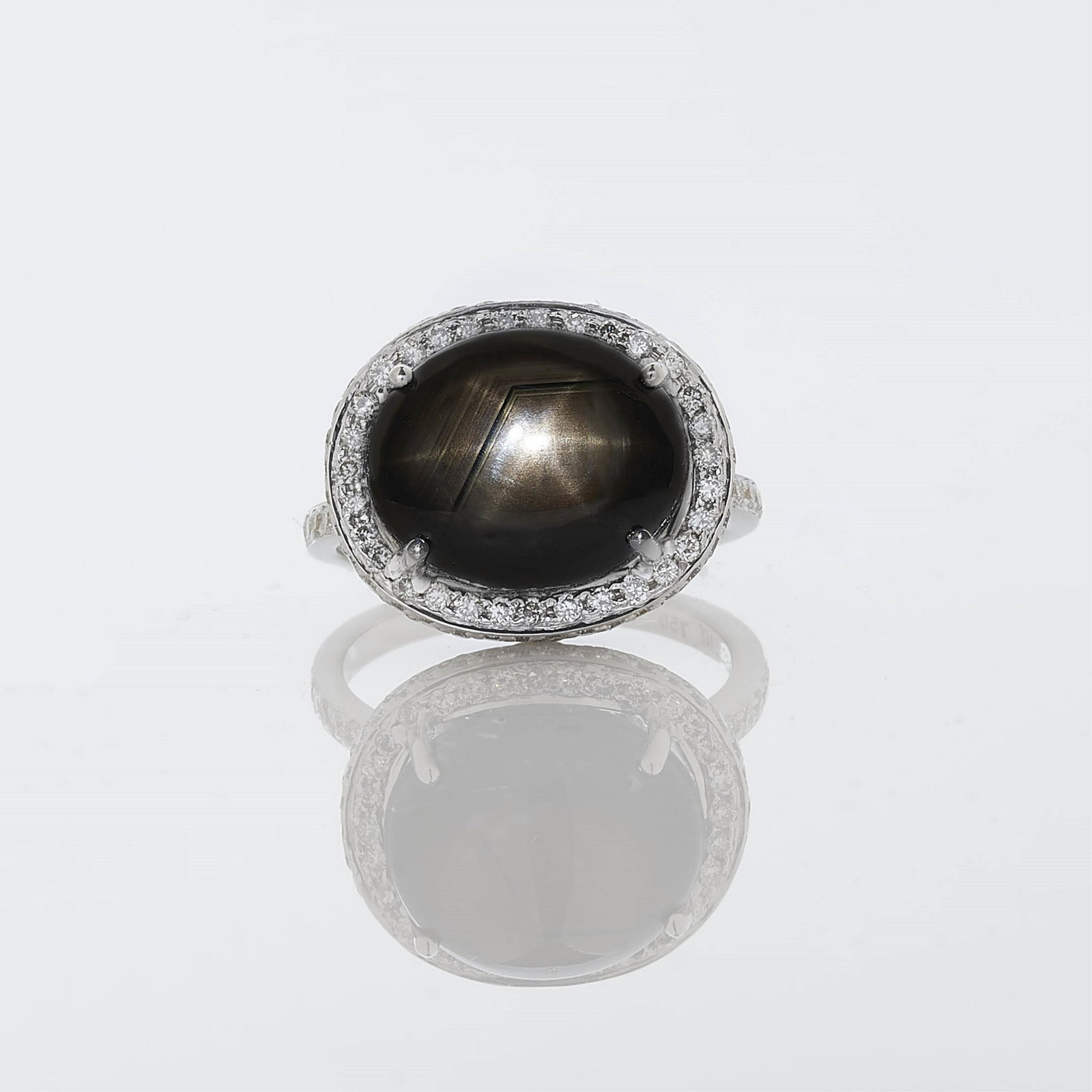 Black Star Sapphire & Diamond Ring, Assil NY: Black Star Sapphire & Diamond Ring by Assil NY. Oval shaped black star sapphire weighing 9.70 cts surrounded by 126 round brilliant cut diamonds weighing 0.90 cts. E-F color, VVS2-VS1 clarity. Set in 