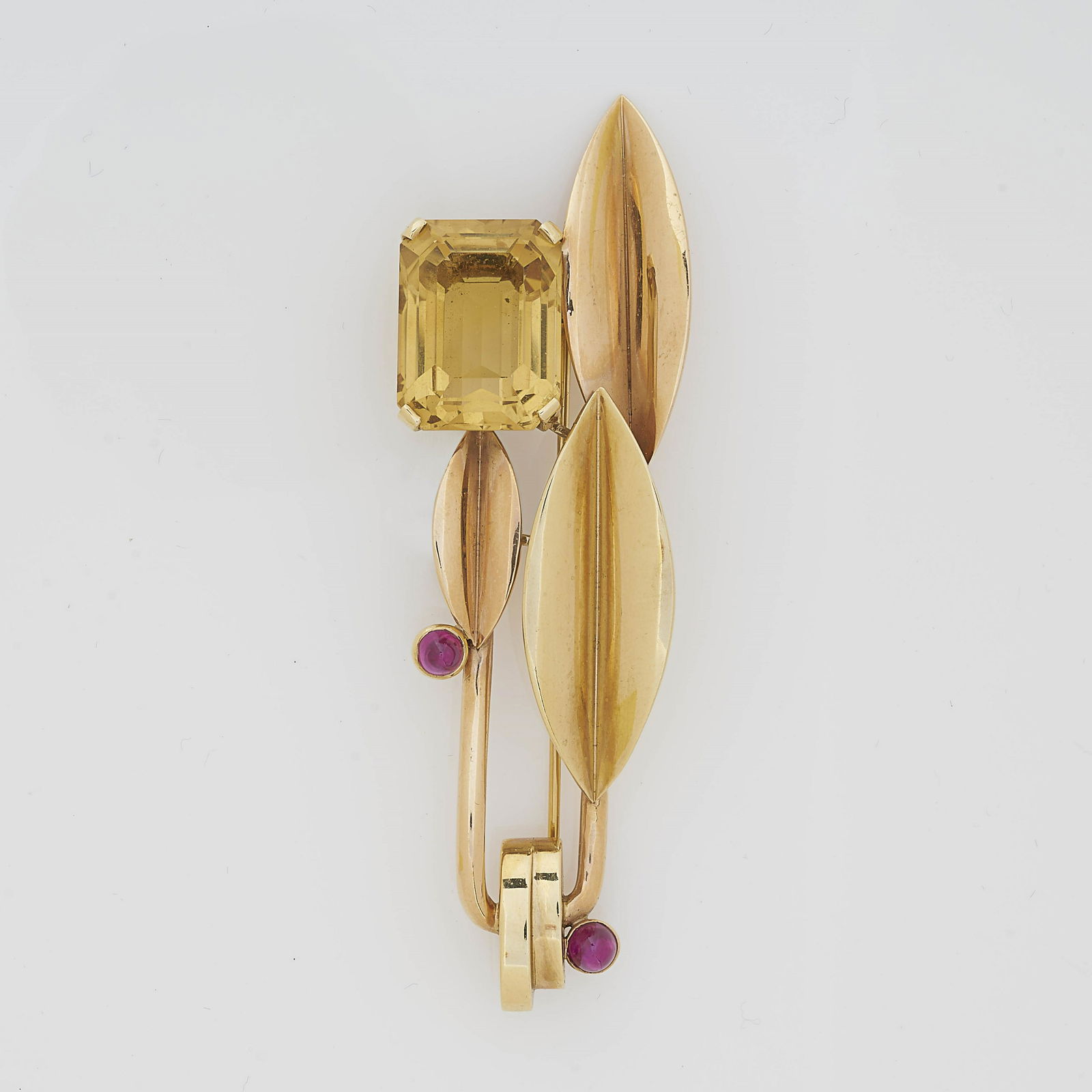 Trabert Hoeffer-Mauboussin Leaf Brooch: Trabert Hoeffer-Mauboussin 'Reflections' leaf brooch with large emerald cut citrine measuring 20 mm x 15.05 mm along with two small 4.65 mm round bezel set cabochon rubies. Marked Trabert Hoeffer-Maub